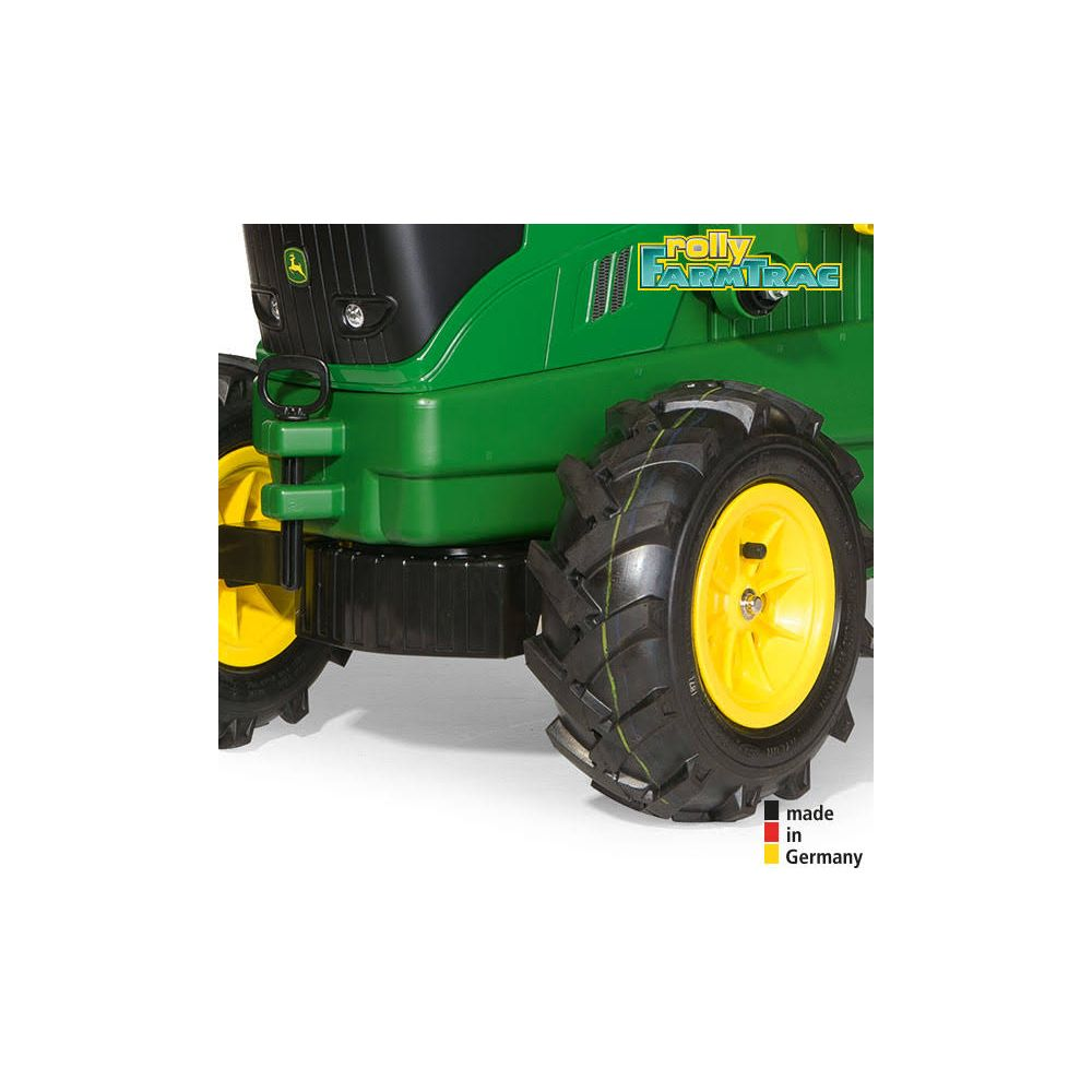 Grüner Spielzeugtraktor mit gelben Felgen und grobstolligen Reifen. Logo und Schriftzug.