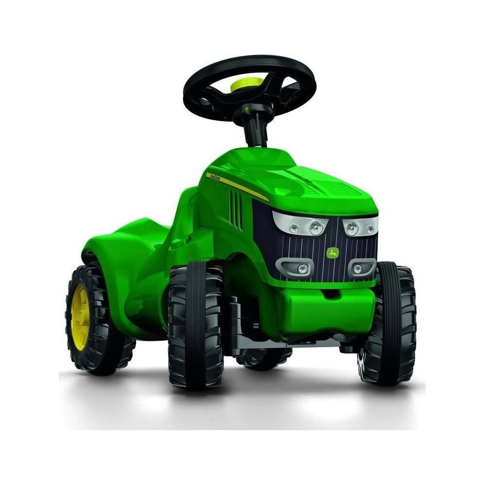 Ein grüner Spielzeugtraktor mit schwarzem Lenkrad und gelben Felgen.