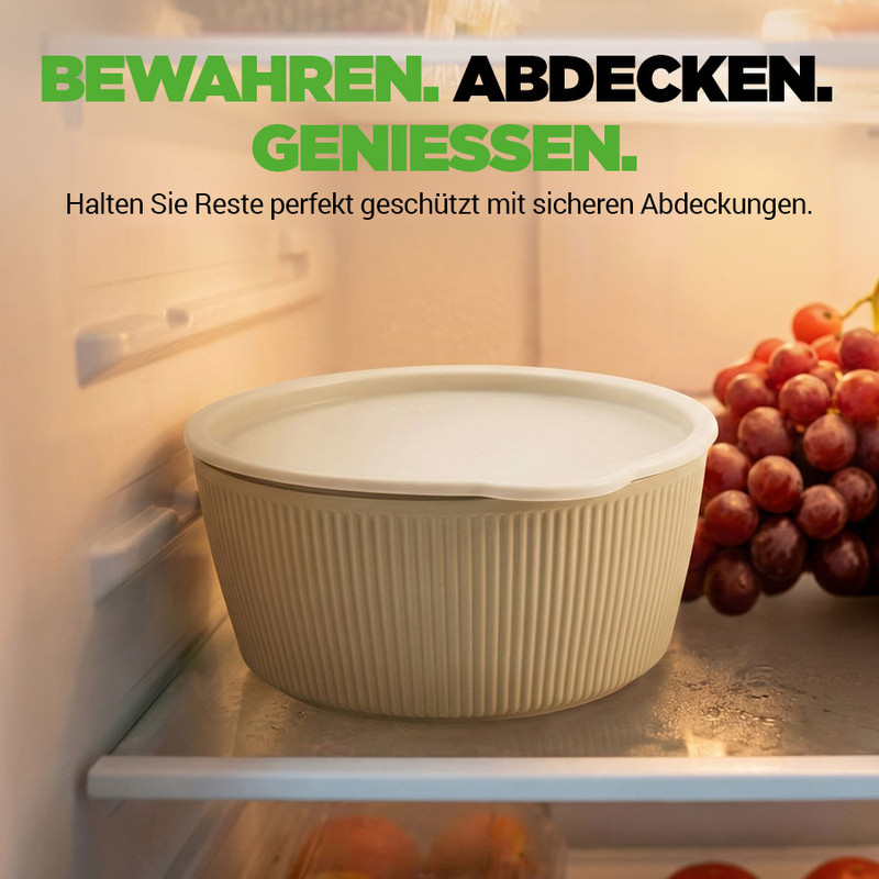 Ein Behältnis mit Deckel steht auf einem Kühlschrankregal neben Trauben.