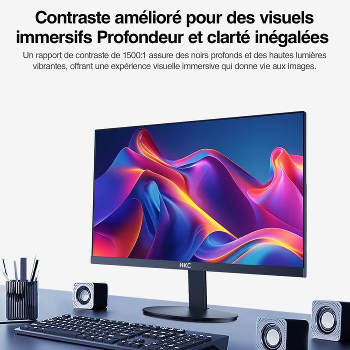 Un monitor con sfondo astratto colorato, tastiera e altoparlanti.