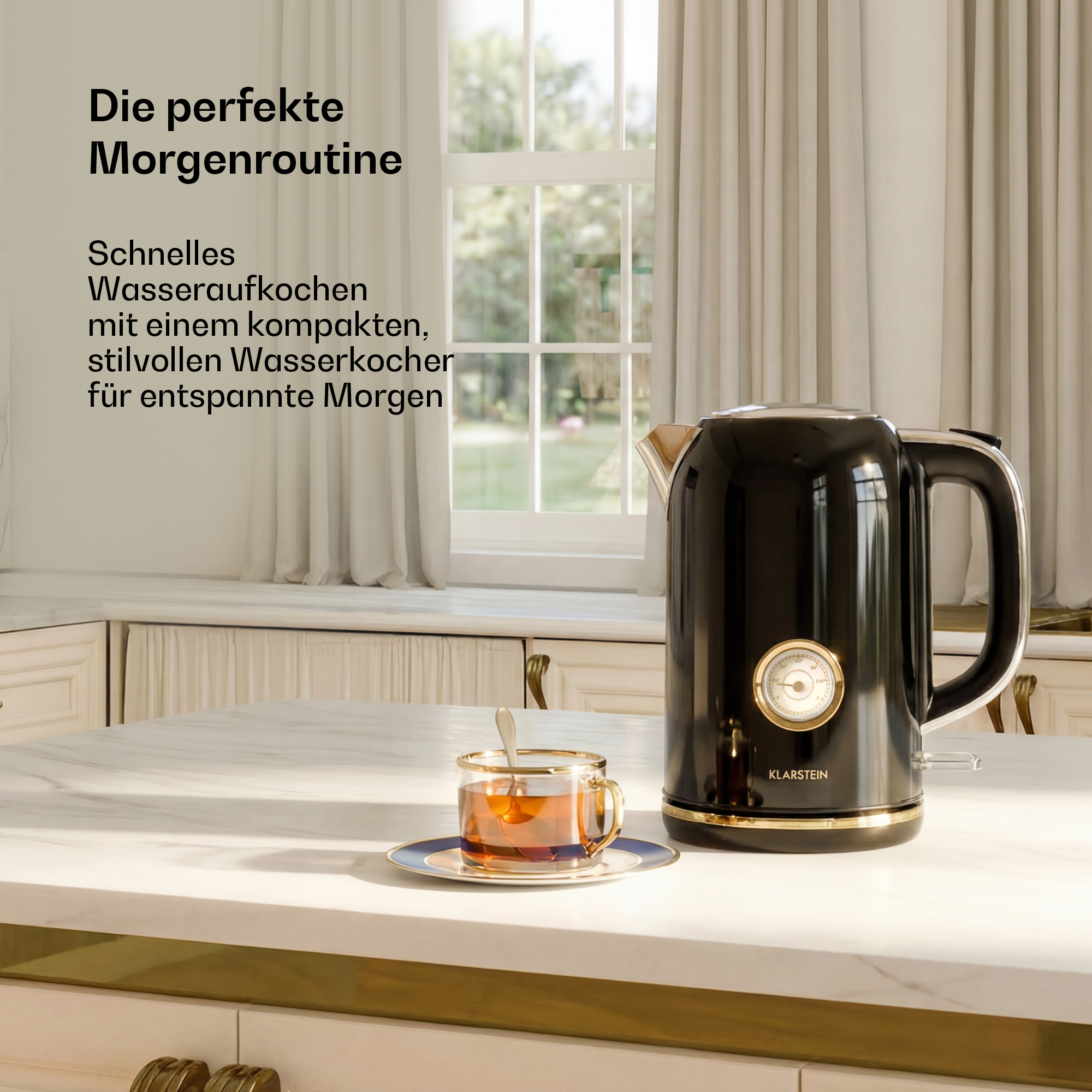 Ein schwarzer Wasserkocher mit Goldrand und Thermometer steht auf einer Marmorplatte neben einer Tasse Tee.