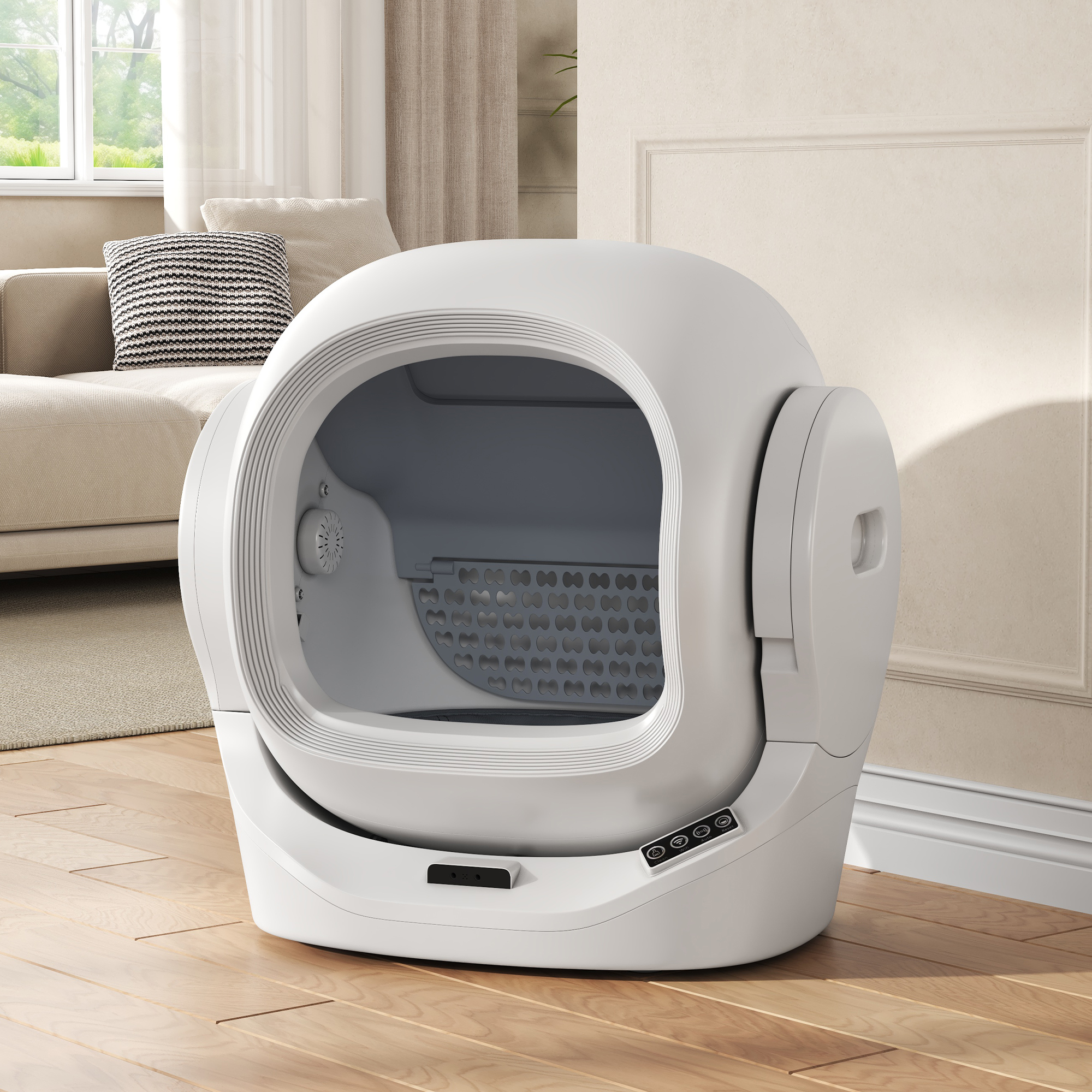 Eine weiße automatische Katzentoilette steht auf einem Holzboden, im Hintergrund ein Sofa und ein Fenster.