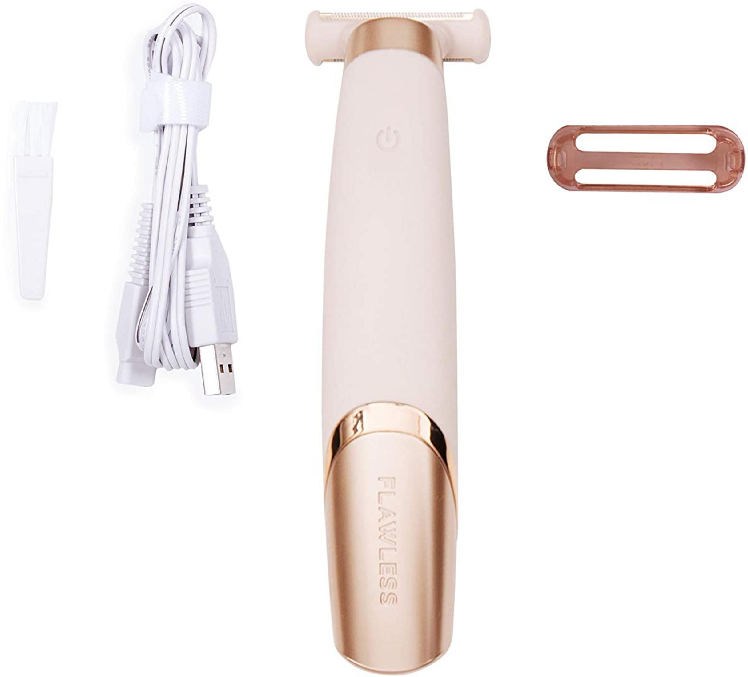 Un rasoio da donna color chiaro con cavo USB, spazzolino e cappuccio.