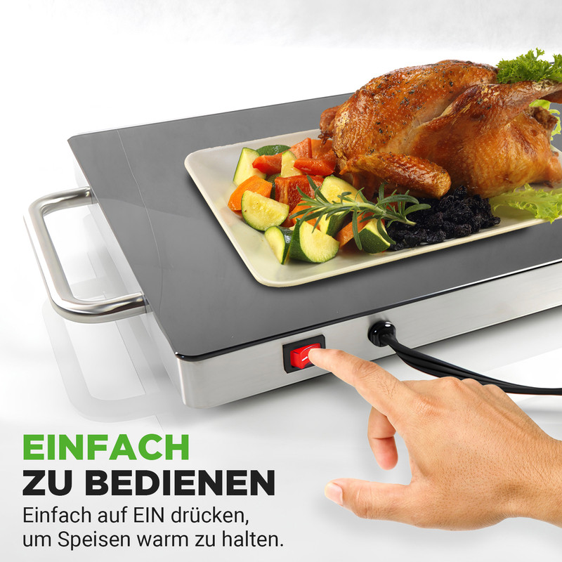 Ein Brathähnchen mit Gemüse auf einem warmhalte Teller, der eingeschaltet wird.