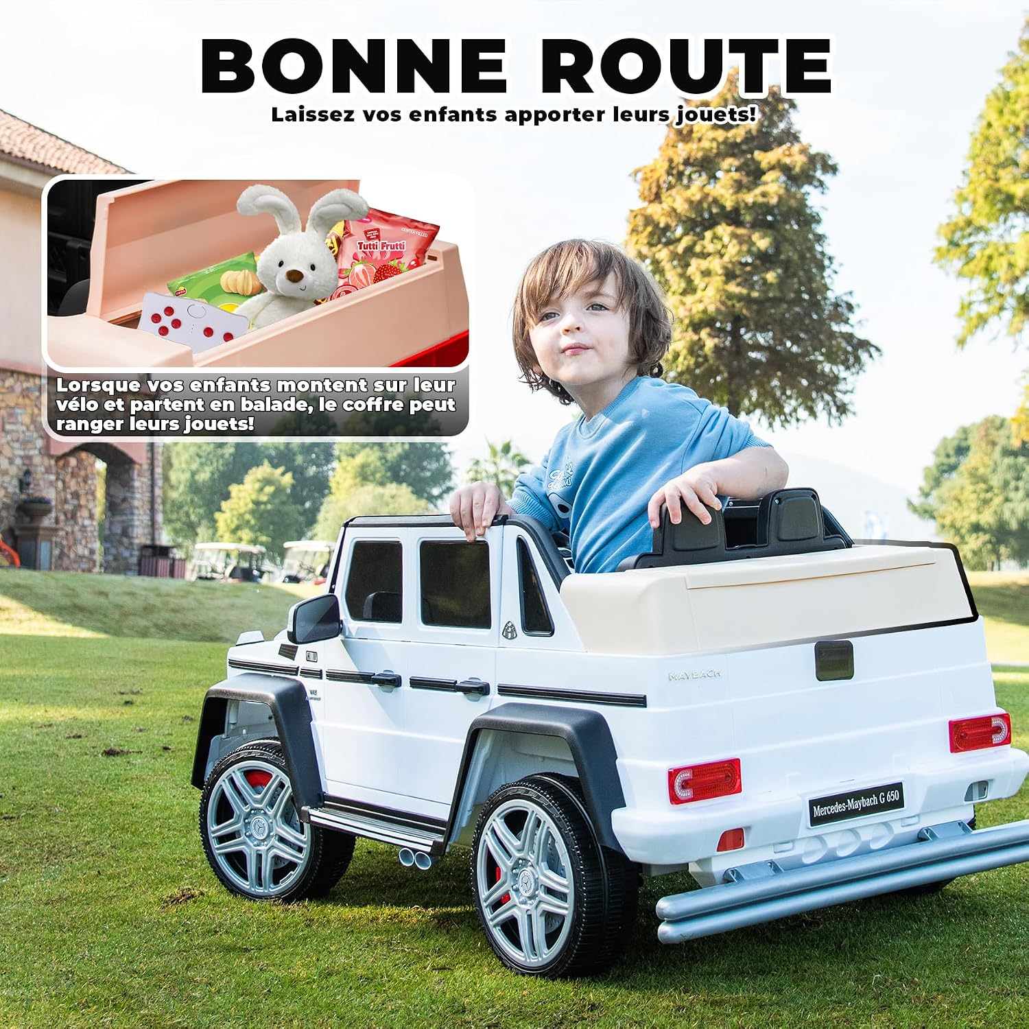 Ein Junge sitzt in einem weißen Spielzeugauto, das auf Gras geparkt ist. Ein Spielzeug im Inneren.