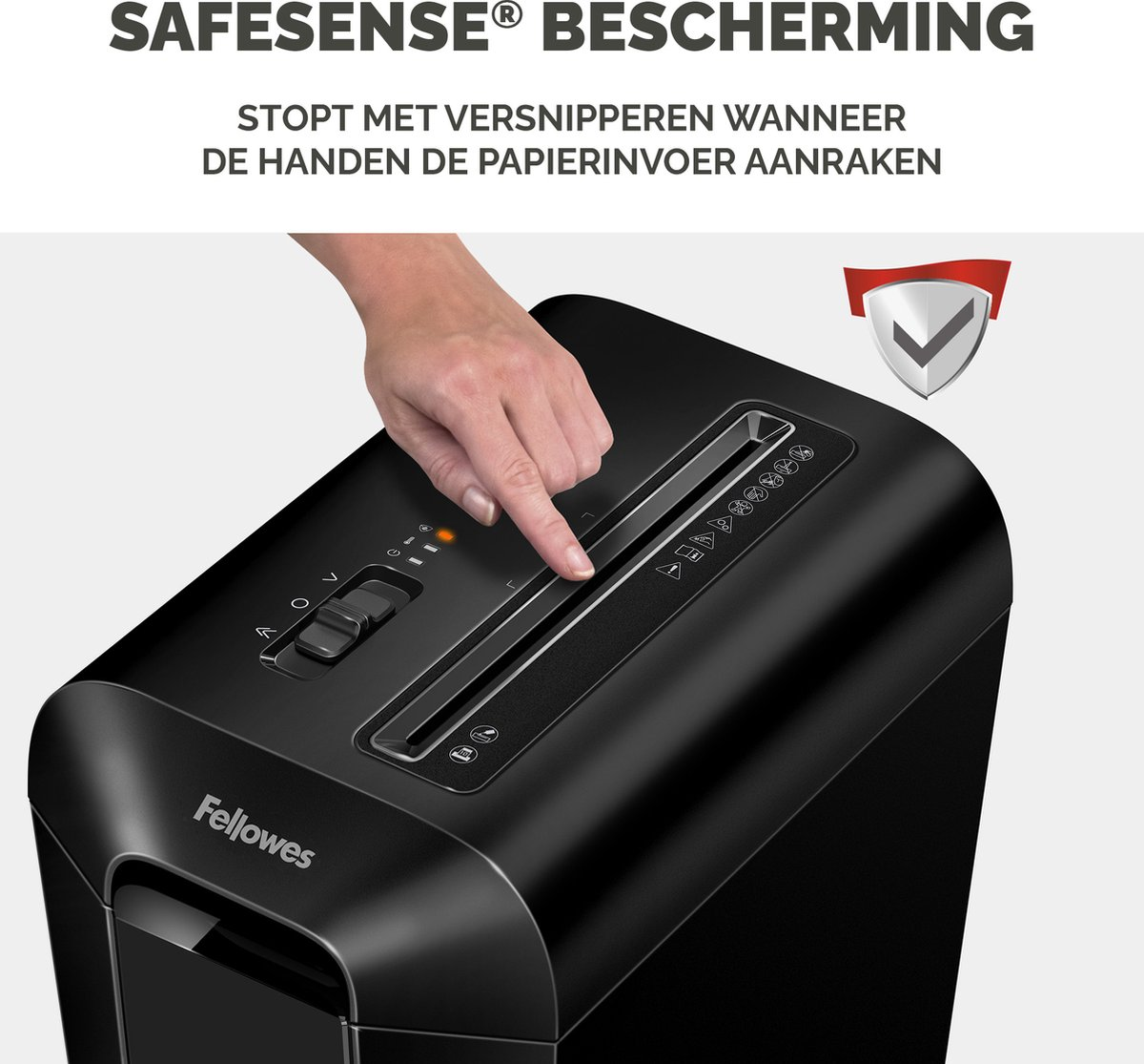 A hand touches a black Fellowes shredder with SafeSense protection.
