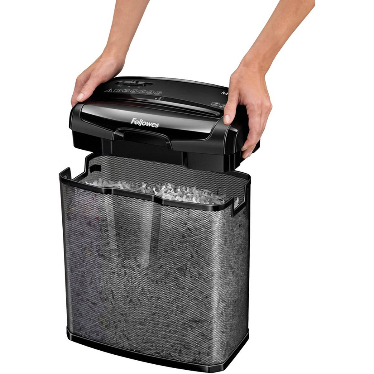 Person lifts black Fellowes shredder over a full shredder bin.