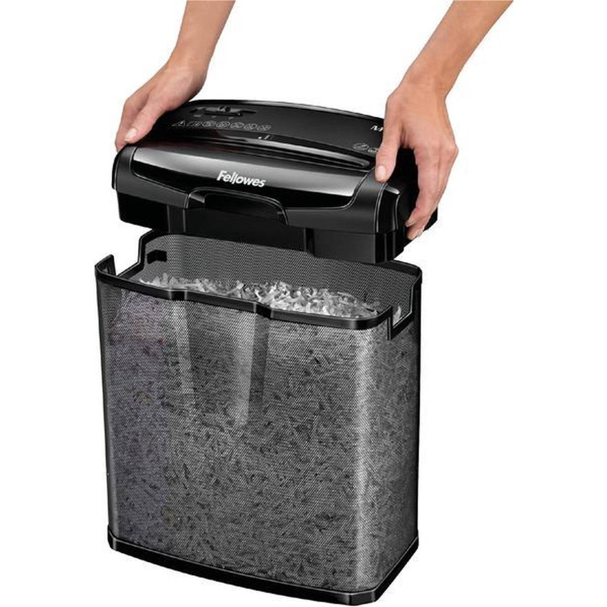 Hands lift black Fellowes shredder over a full, mesh waste bin.