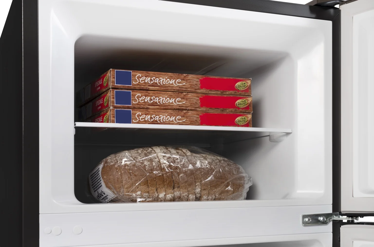 A loaf of bread in plastic and three pizza boxes inside a refrigerator.