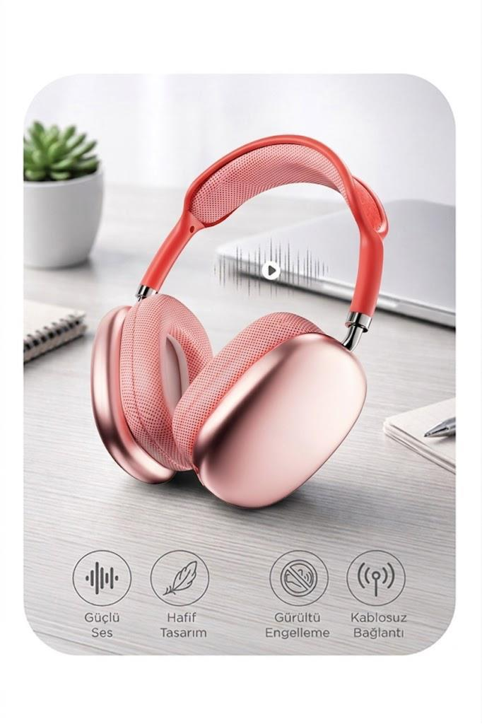 Gül altın rengi kulaklık, kırmızı kafa bandı, masa üzerinde bitki ve laptop.