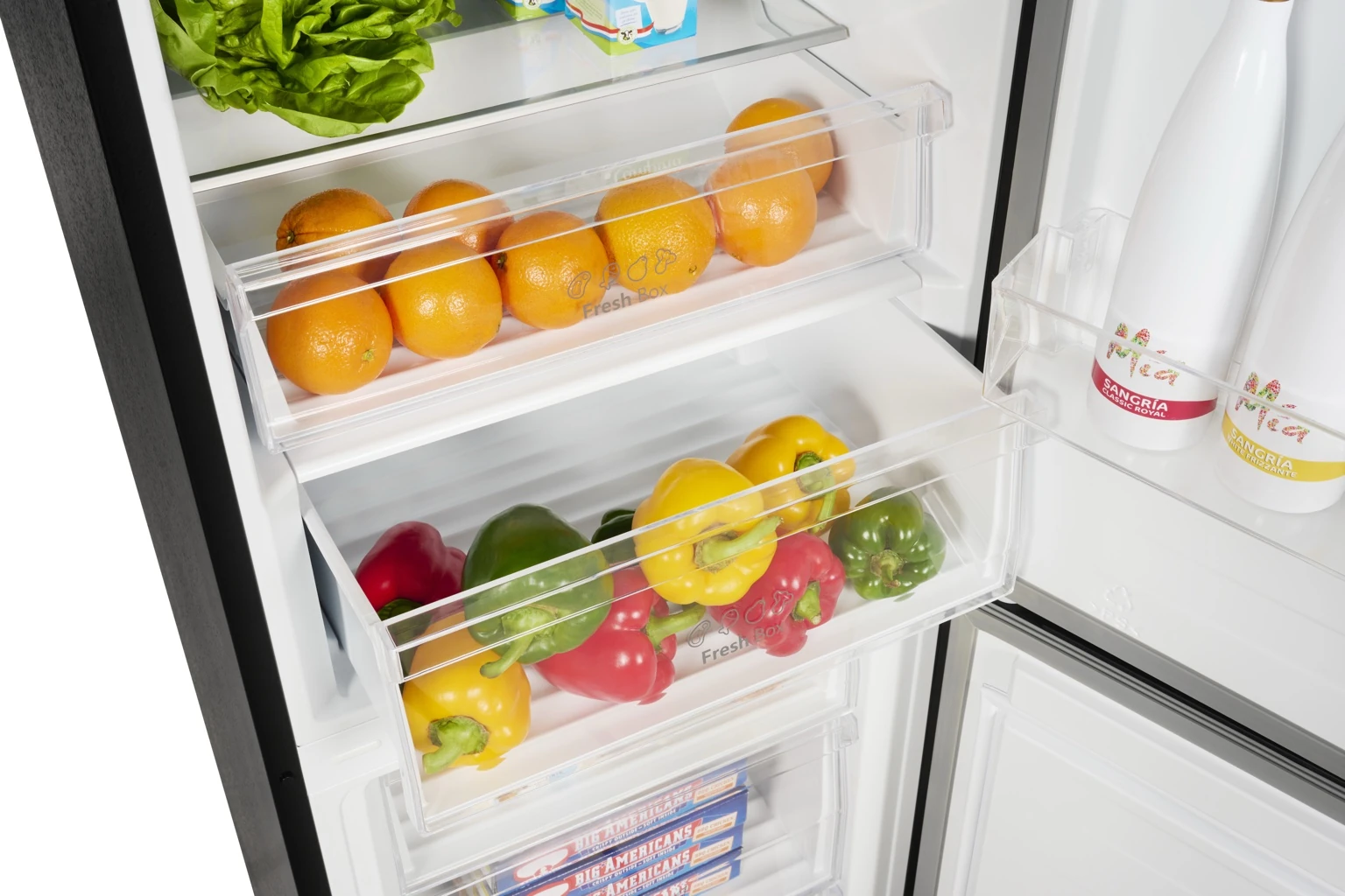Open refrigerator with fresh oranges, colorful bell peppers, and bottles of sangria.