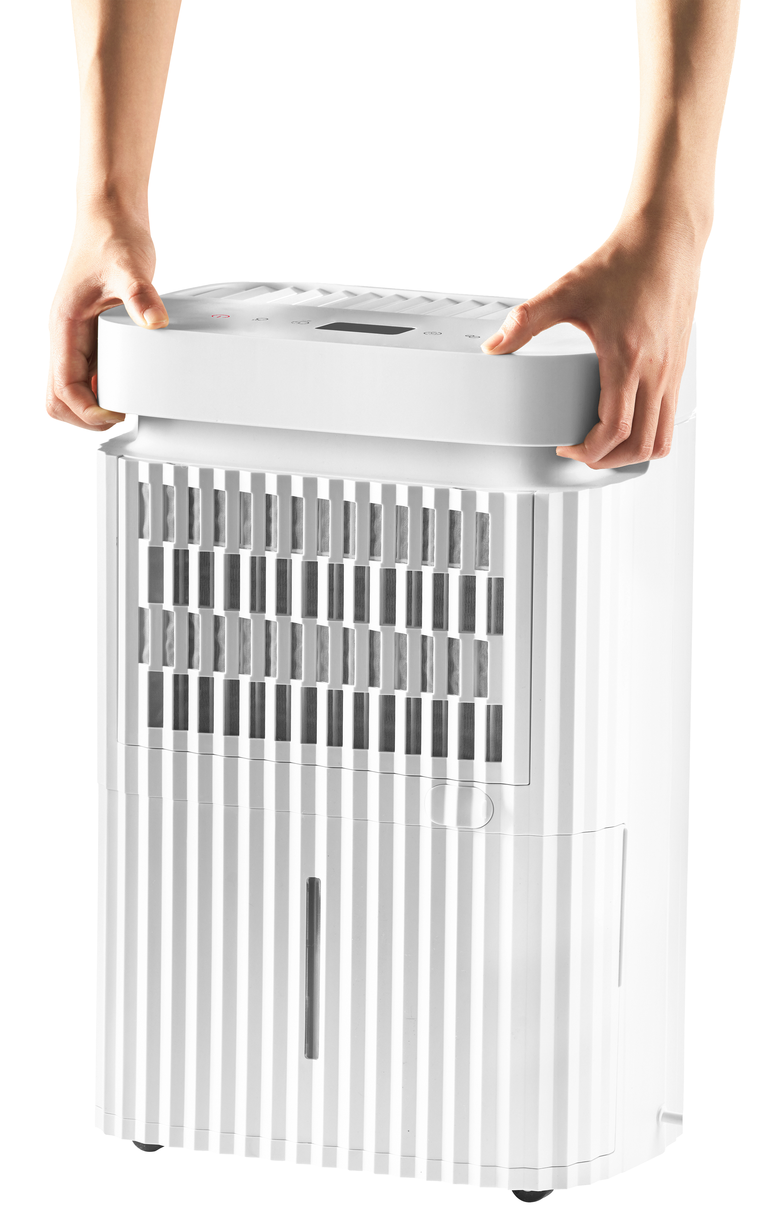 Two hands grasp a white dehumidifier with ventilation slits.