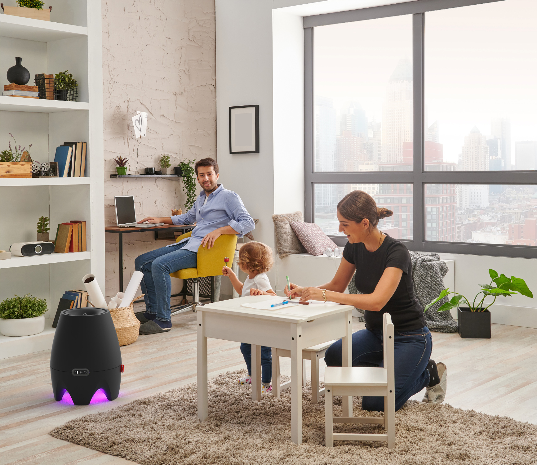 Family in living room: Dad at desk, mom and child at small table drawing.