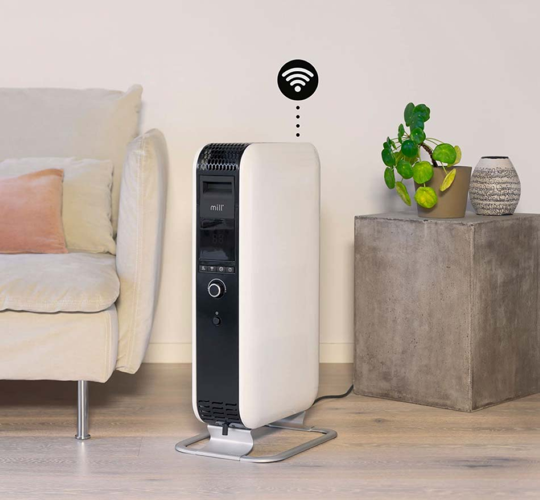 A white radiator with a black front stands next to a sofa and a side table.