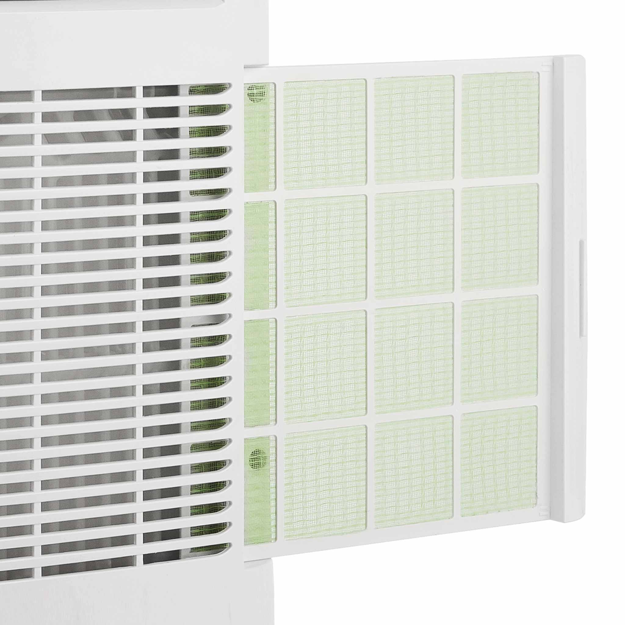 White air conditioner with removable light green filter grid, close-up.