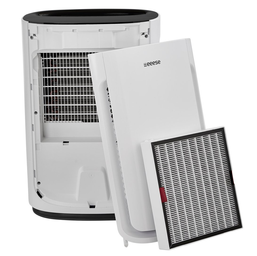 A white air purifier with its filter removed. The interior is visible.