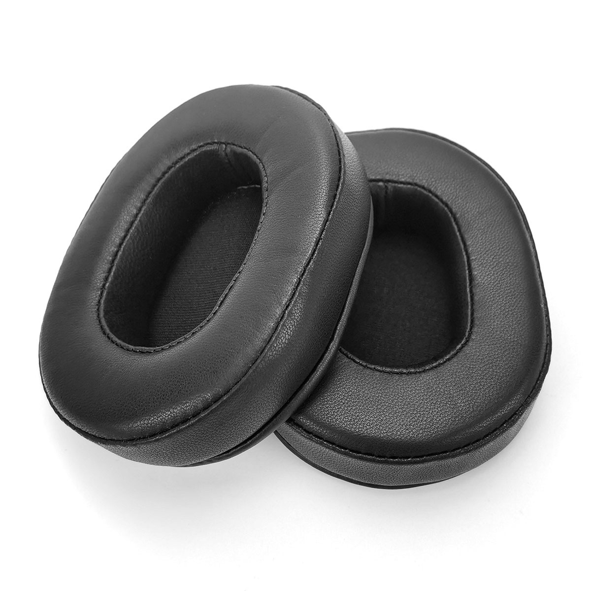 Two black, oval leather ear pads are placed side-by-side on a white background.