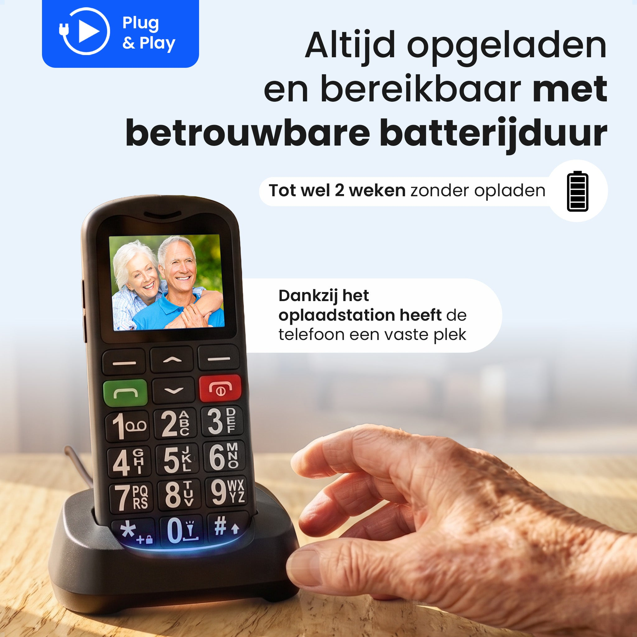 A senior-friendly mobile phone with a large screen and keypad, placed in its charging dock.