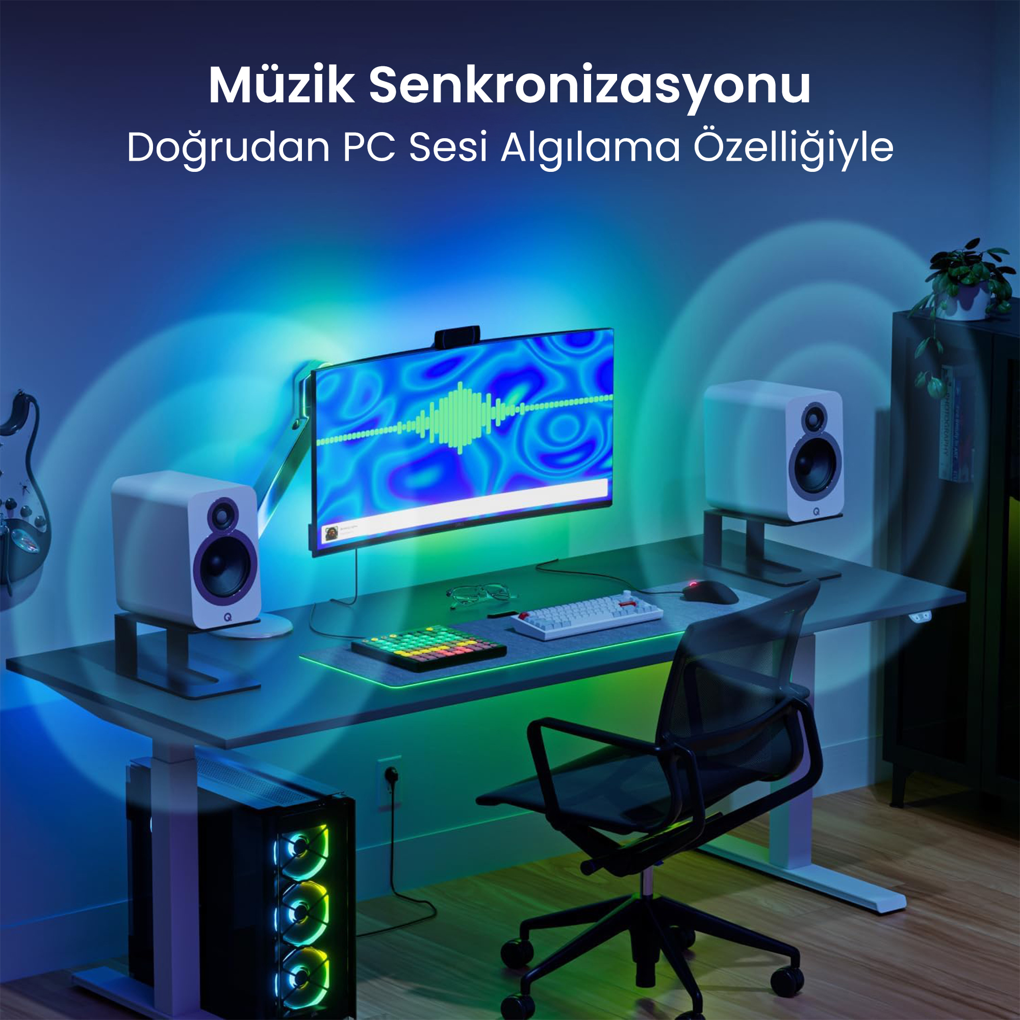 PC, monitör, hoparlör ve gitar bulunan bir masa. Işıklar müziğe senkronize olur.