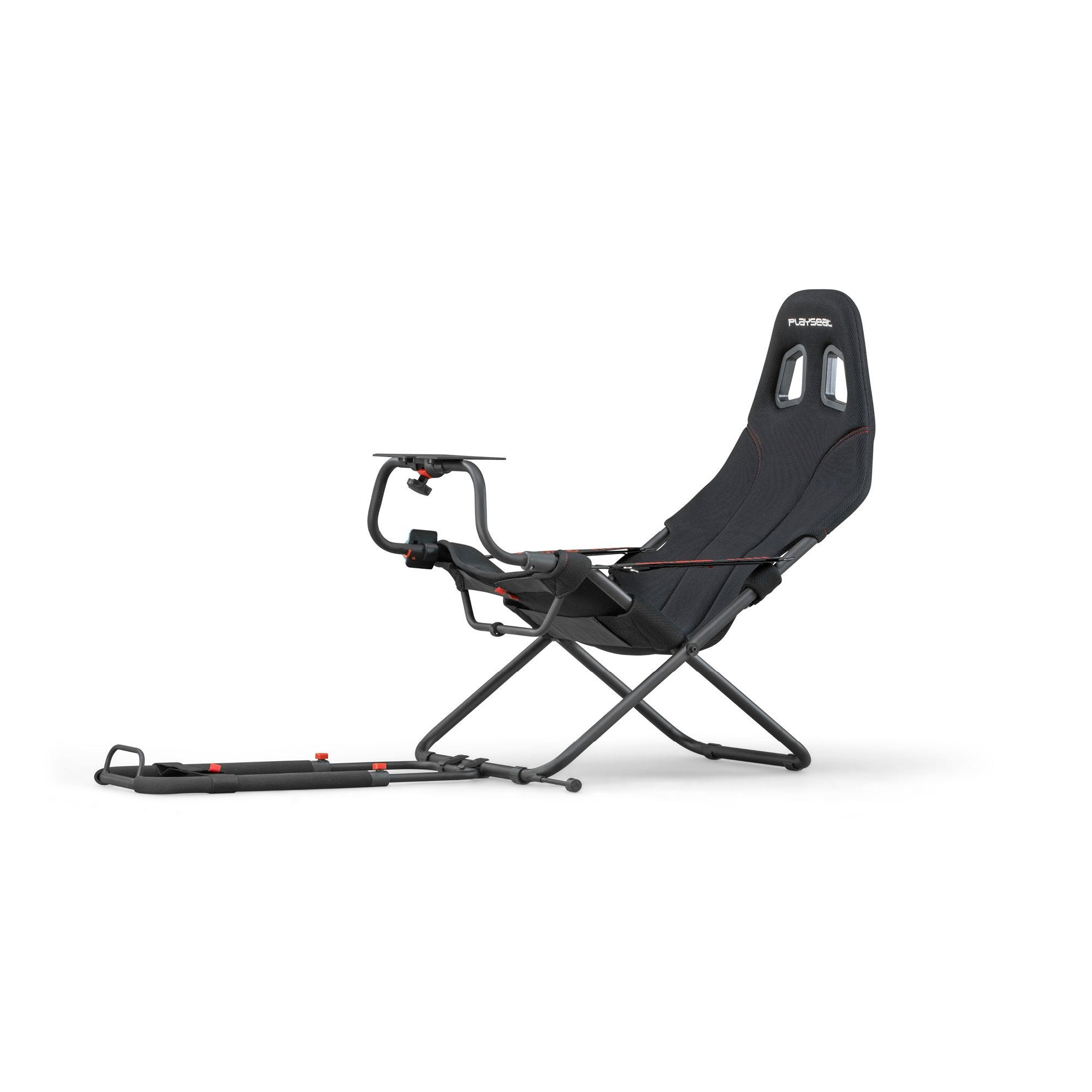 A black gaming chair with a table mount and a footrest.