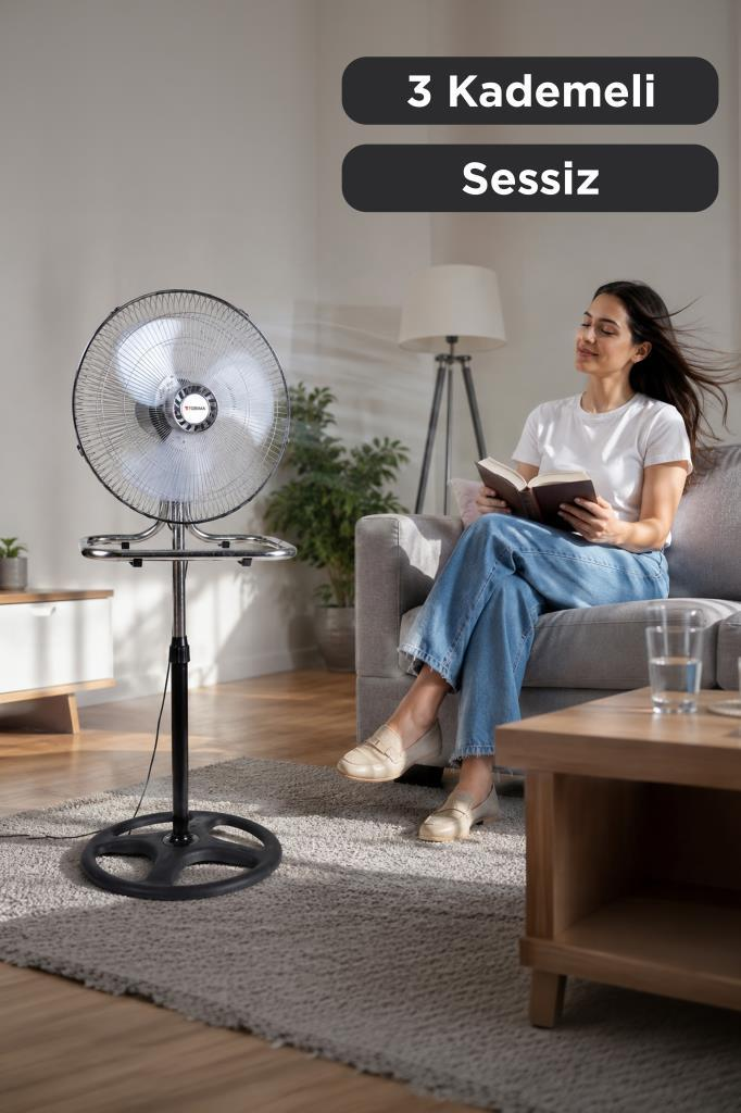 Kadın kitap okurken vantilatör ona doğru hava üflüyor.