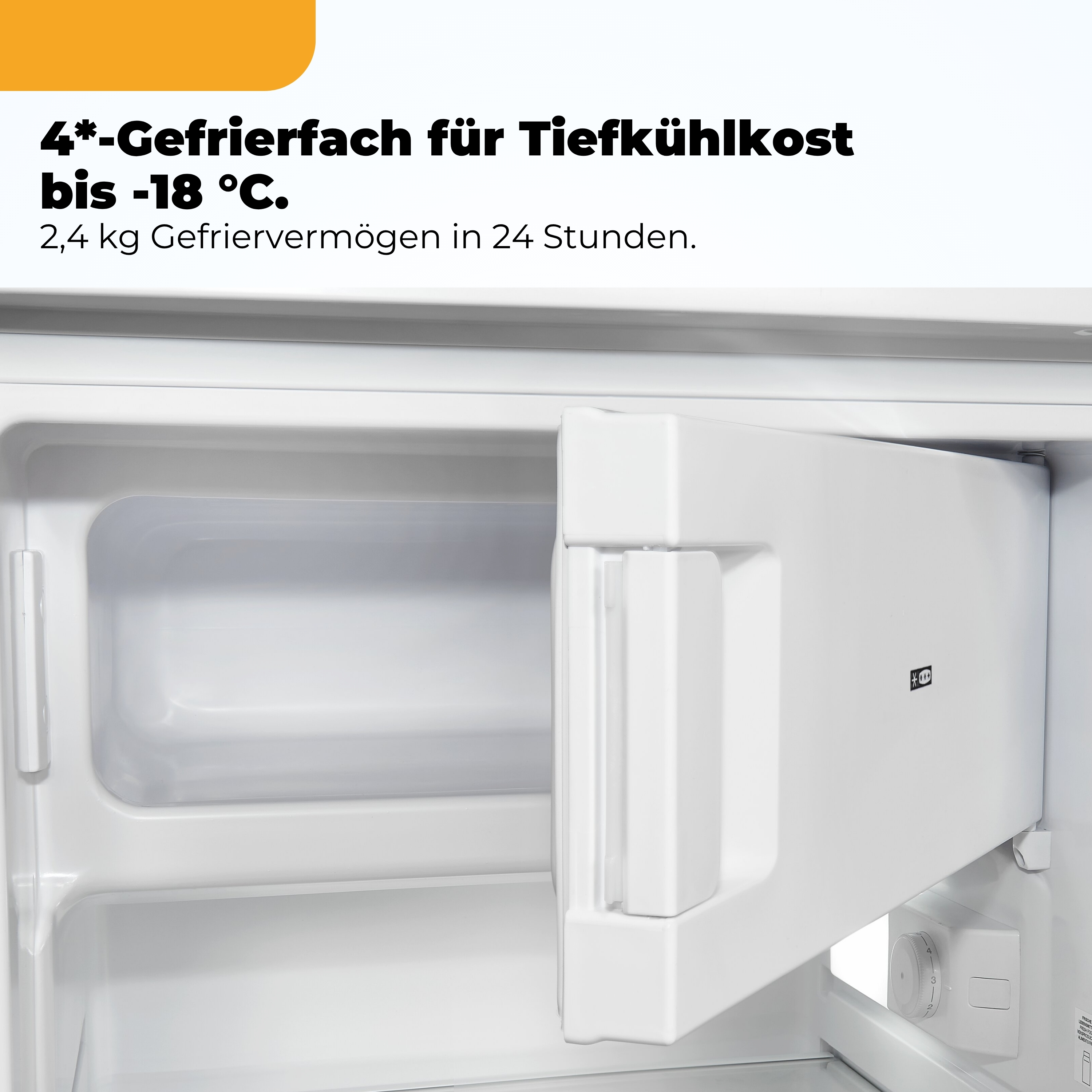 Ein leeres weißes Gefrierfach mit einem Temperaturregler.