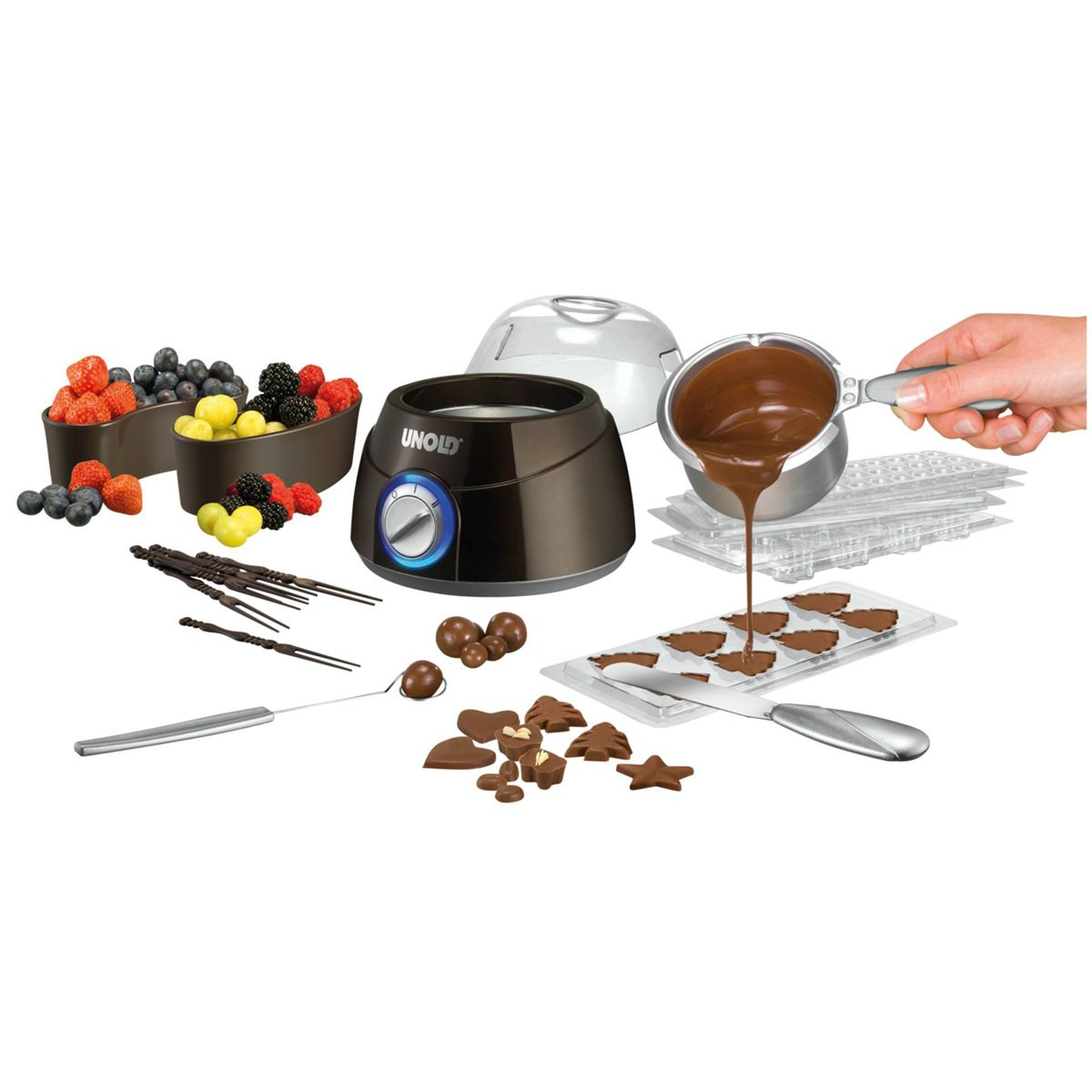 Set per fonduta di cioccolato con frutta, cioccolato fuso e stampi.