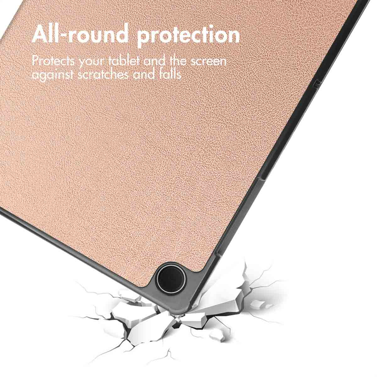 A rose gold tablet case falling onto cracked ground.