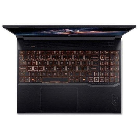 Un portátil negro abierto con teclado iluminado y una imagen de fondo detallada.