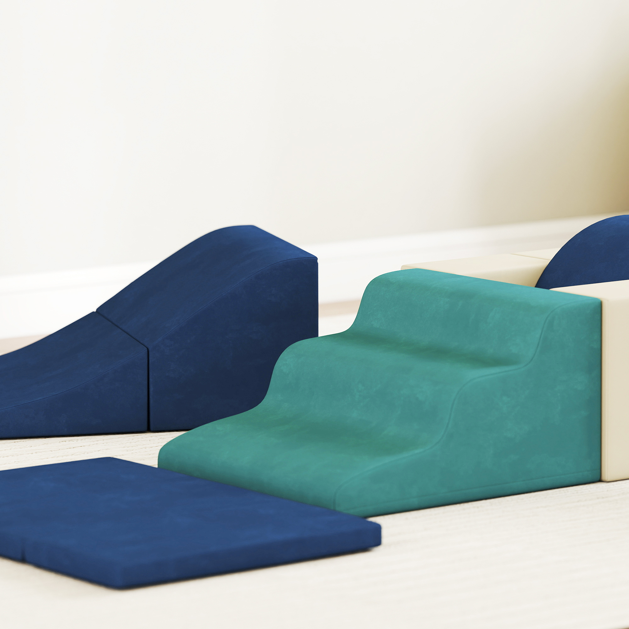 Cuscini morbidi blu e verdi di varie forme, inclusi gradini e rampe.