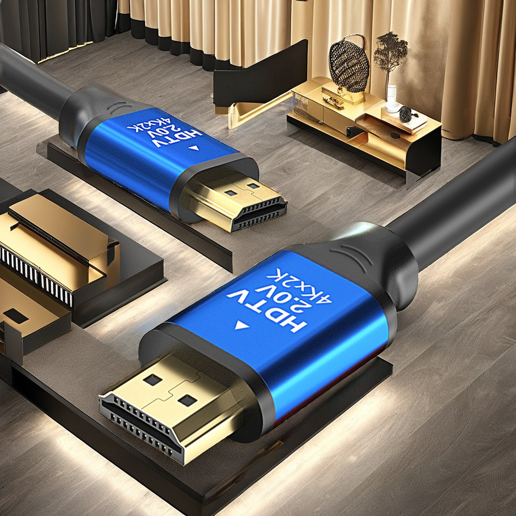 Altın konektörlü, mavi işaretli iki HDMI kablosu masanın üzerinde duruyor.