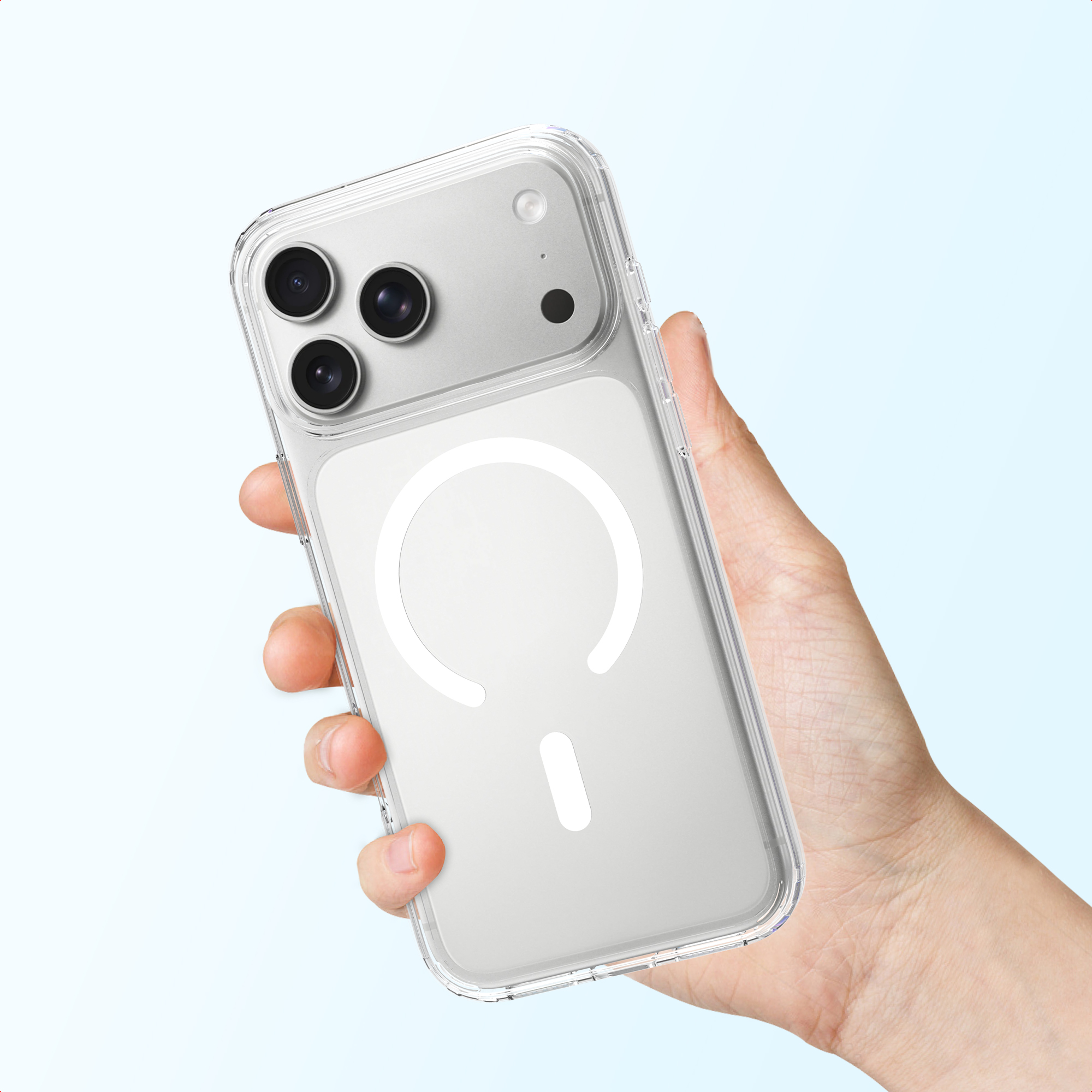 A hand holds a clear phone case with a MagSafe circle on a light blue background.