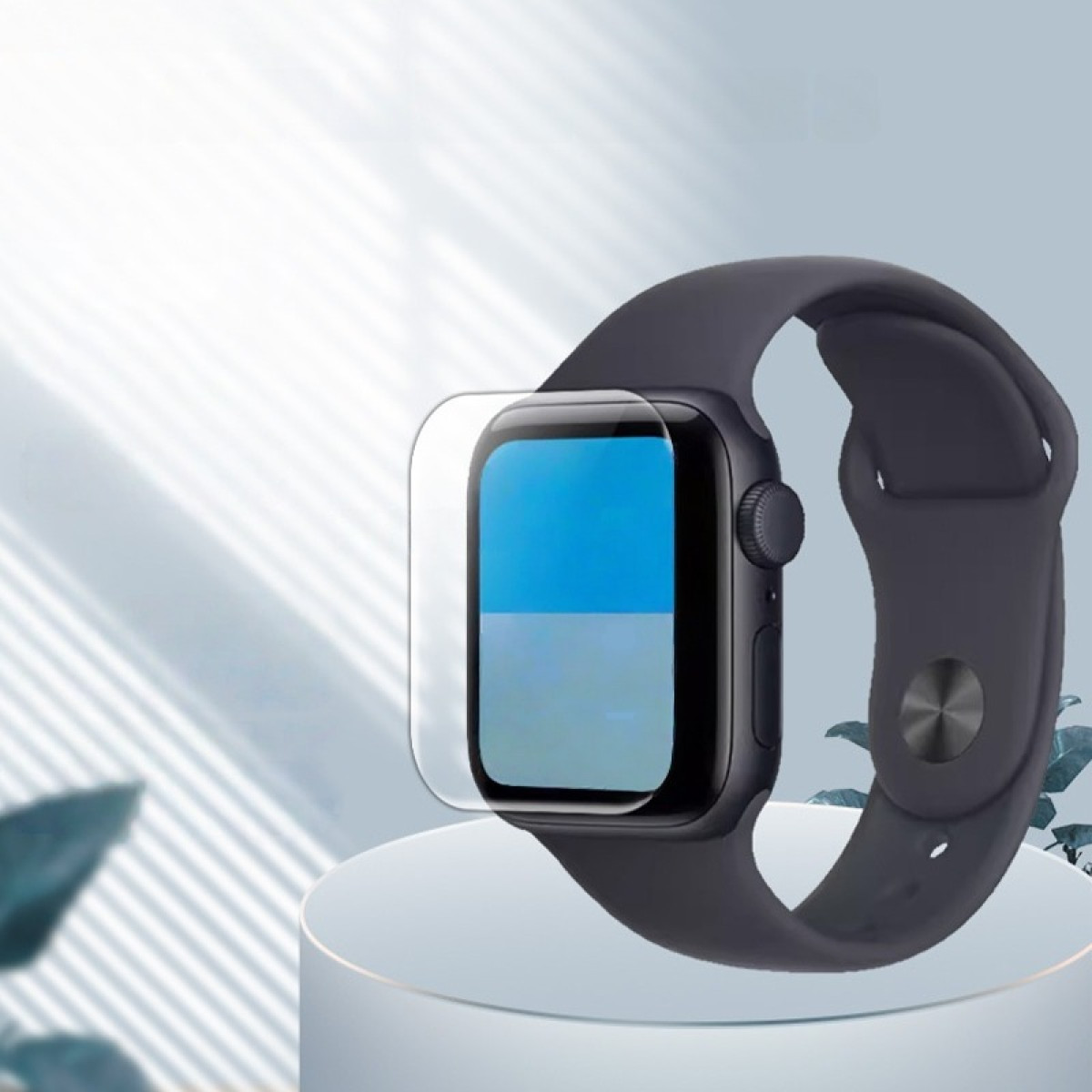 Eine dunkle Smartwatch mit Displayschutzfolie auf einem weißen Podest.