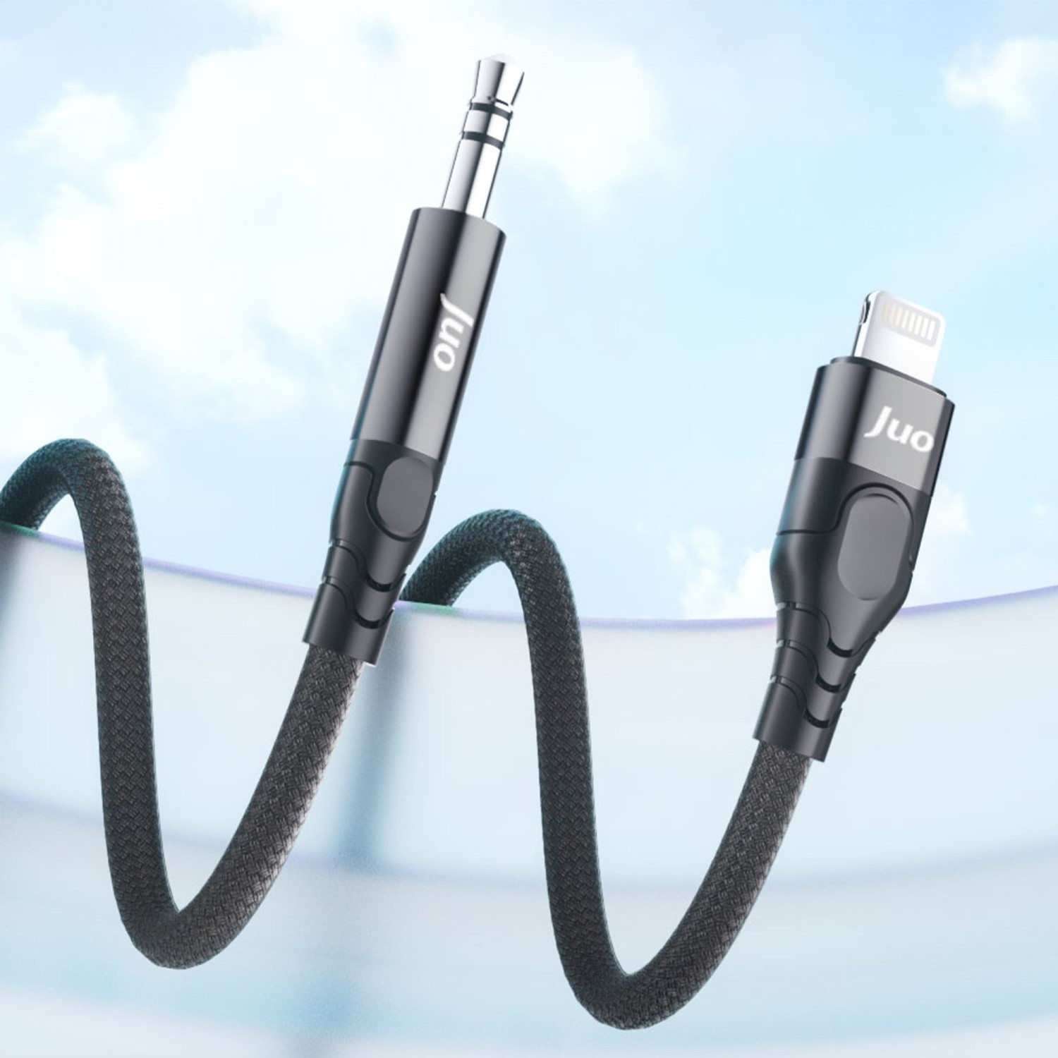 Mavi gökyüzü önünde 3,5 mm jak ve Lightning konektörlü siyah JUO kablosu.