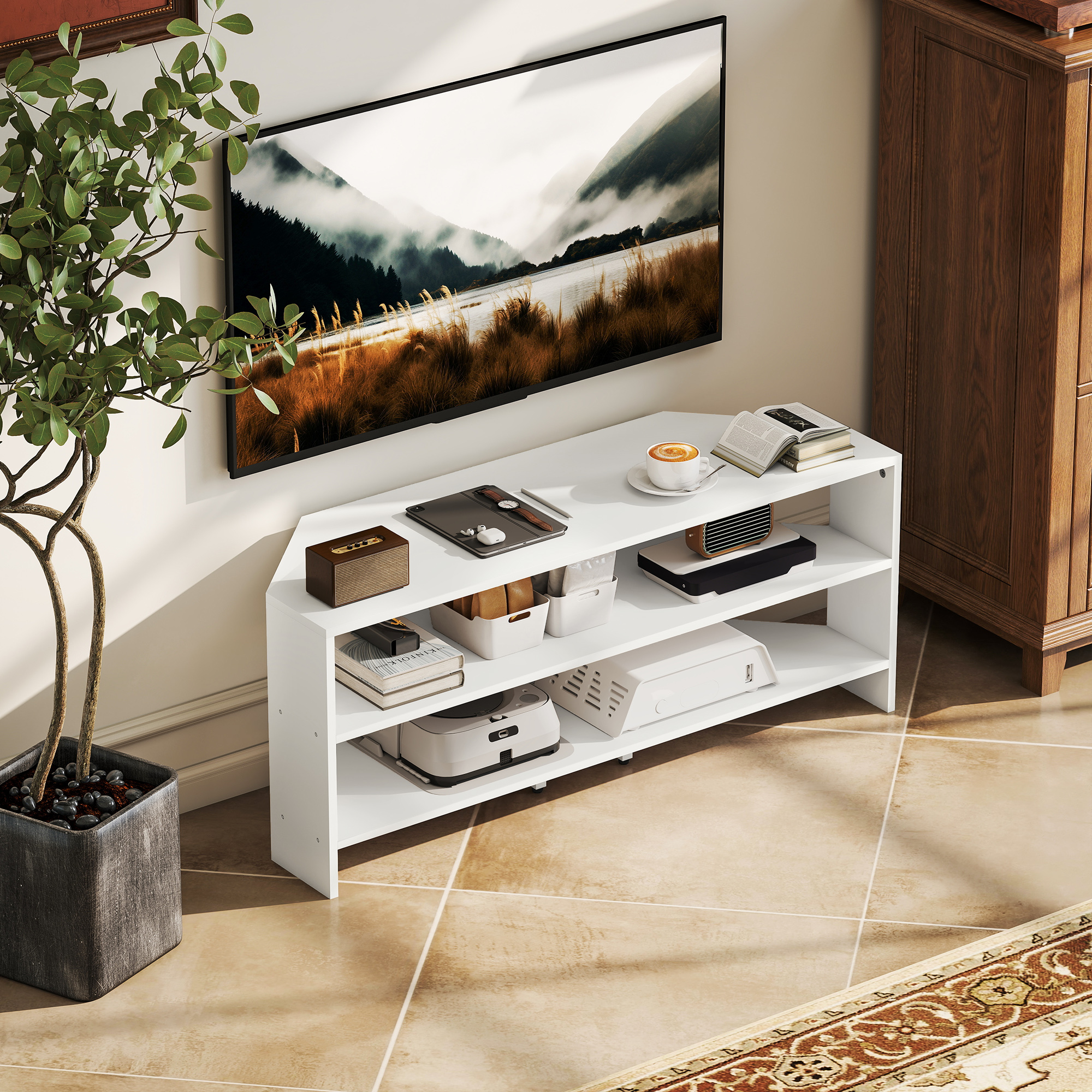 Un moderno mobile TV bianco con elettronica, libri e una pianta.