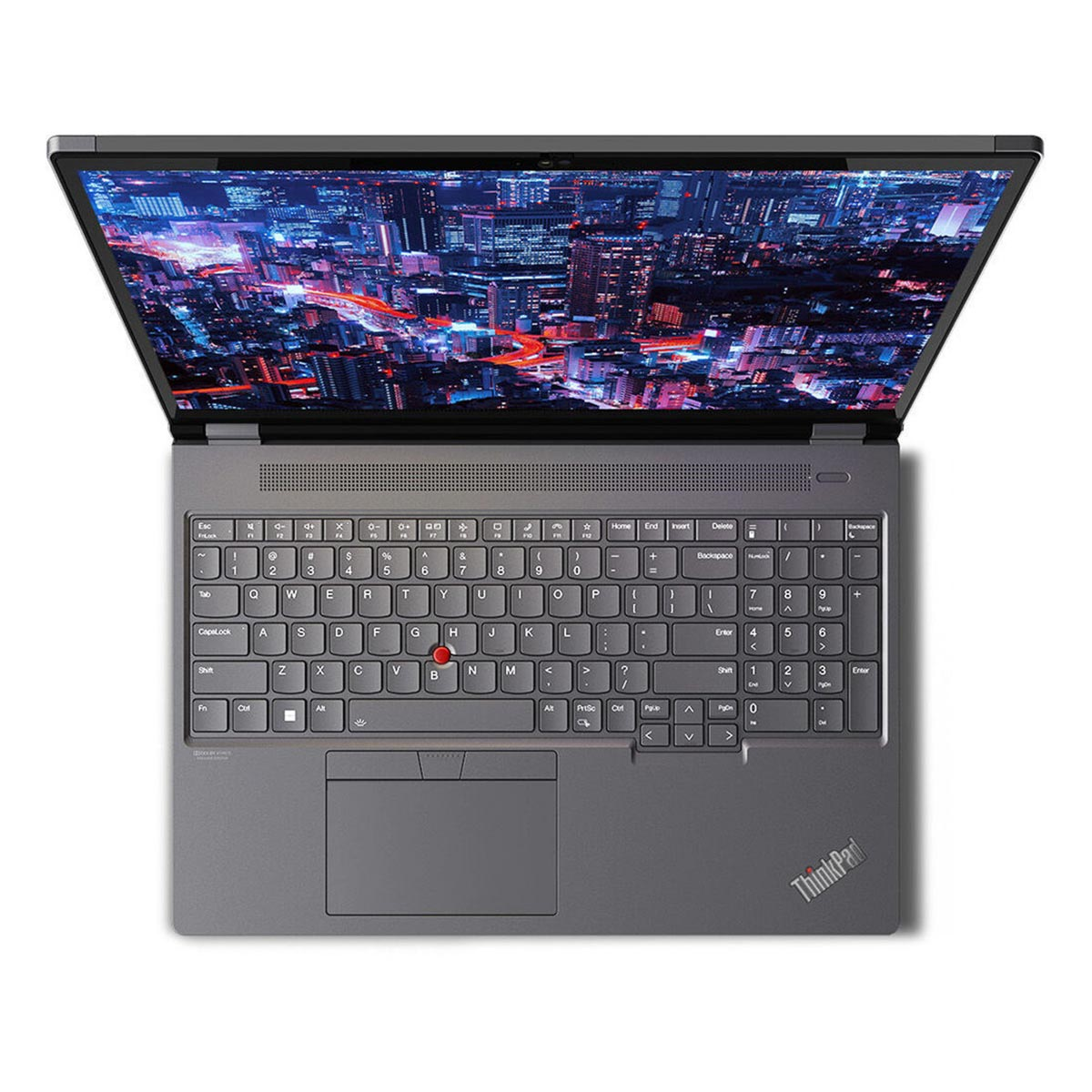 Widok z góry otwartego szarego laptopa wyświetlającego żywe miejskie niebo na ekranie.