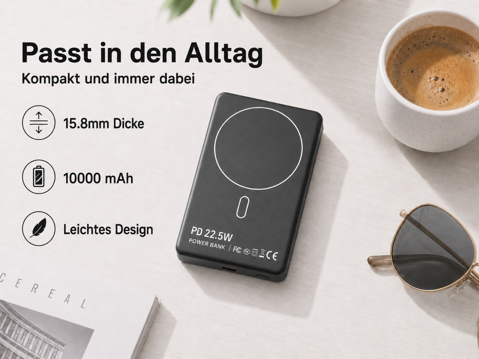 Schwarzes Powerbank mit 10000 mAh, 15,8 mm dick, auf Tisch mit Kaffee und Brille.