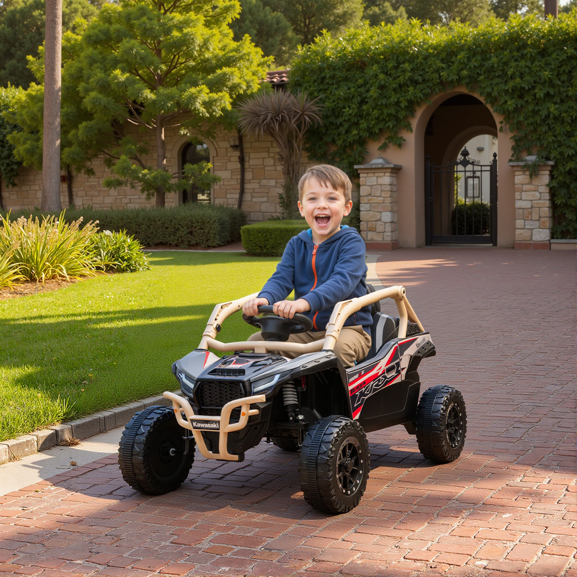 Un bambino guida un ATV giocattolo nero marca Kawasaki su un sentiero di mattoni.