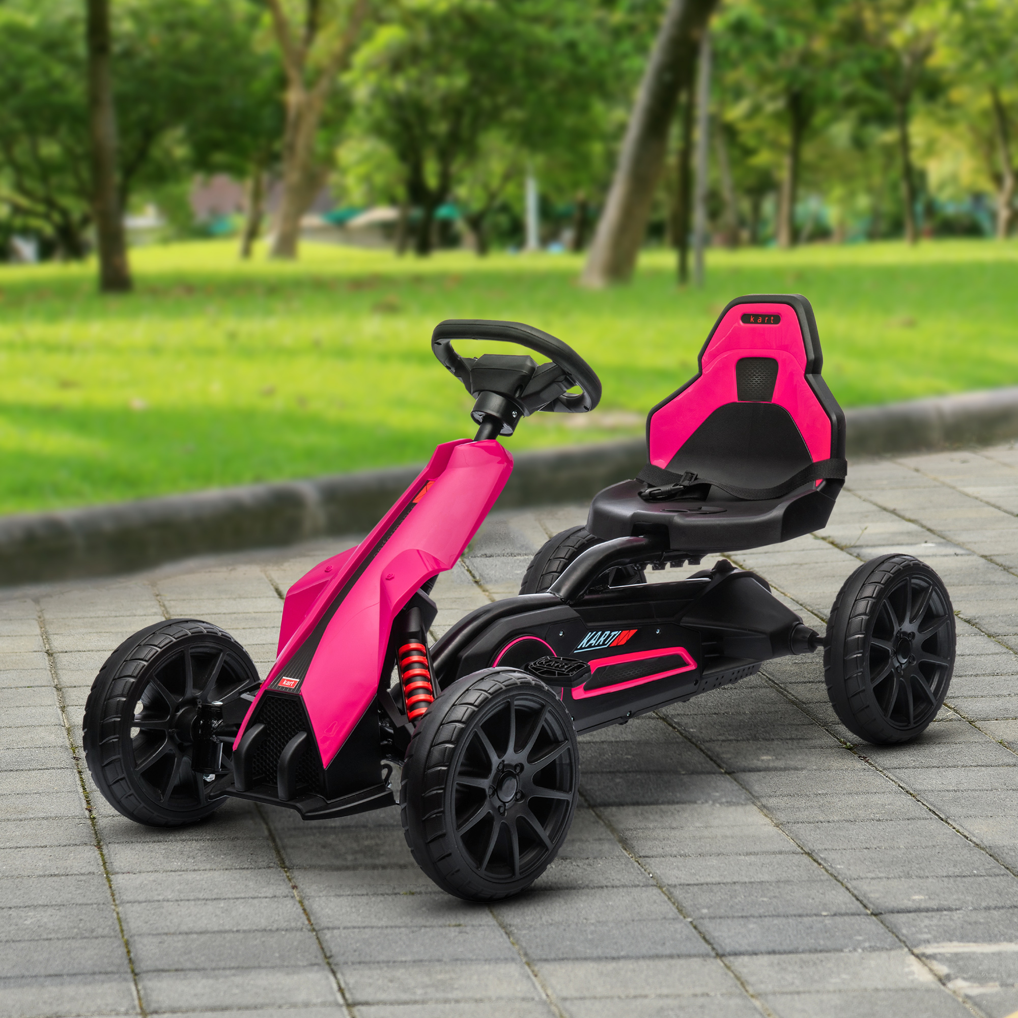 Un go-kart rosa con sedile e volante neri si trova su un sentiero del parco.
