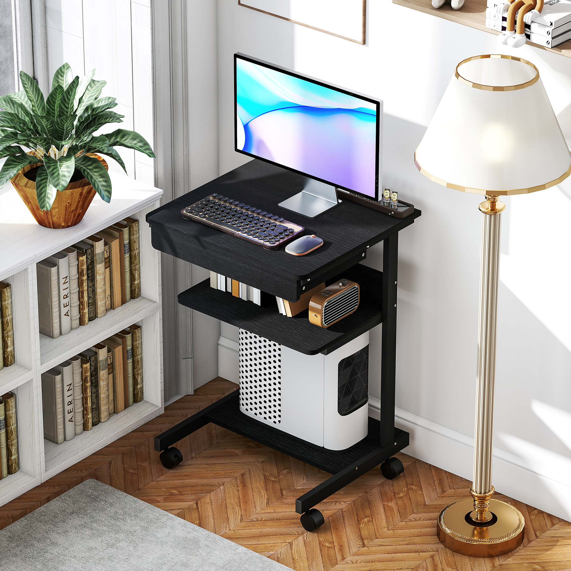 Una scrivania mobile ospita monitor, tastiera, mouse e case del computer.