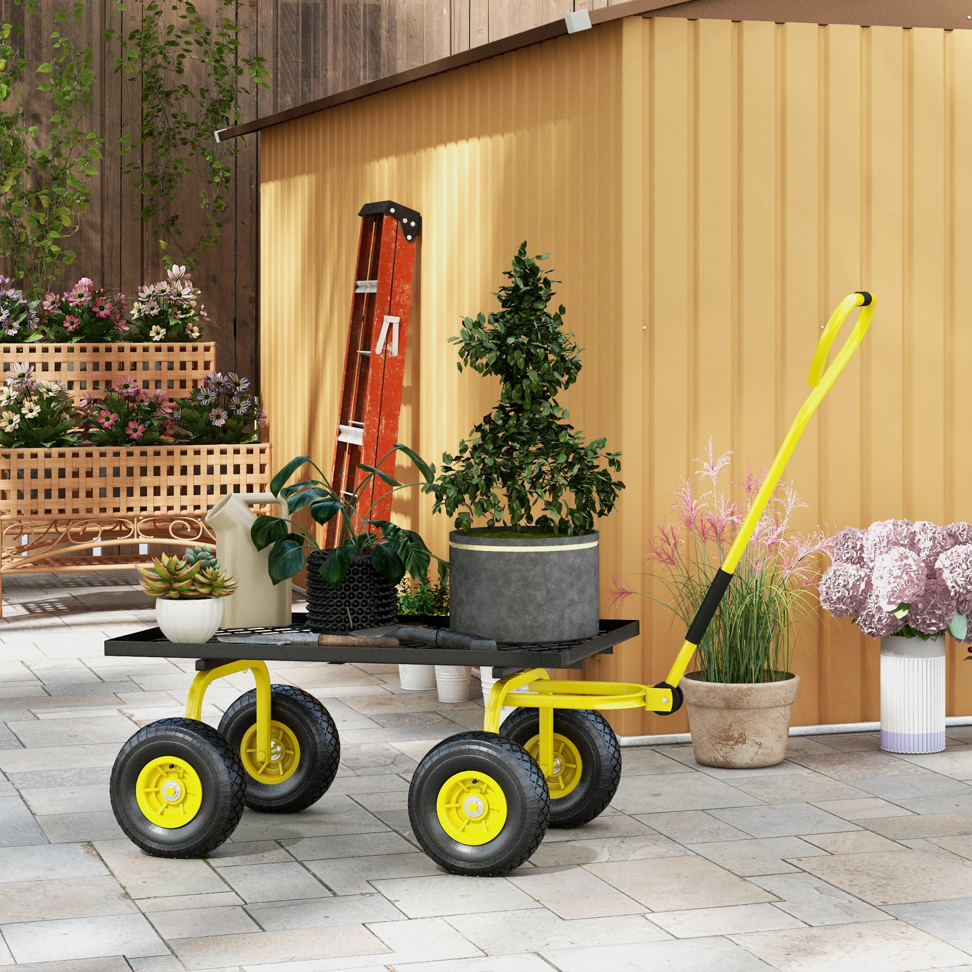 Un carrello da giardino giallo con piante, una scala e attrezzi davanti a un capanno.