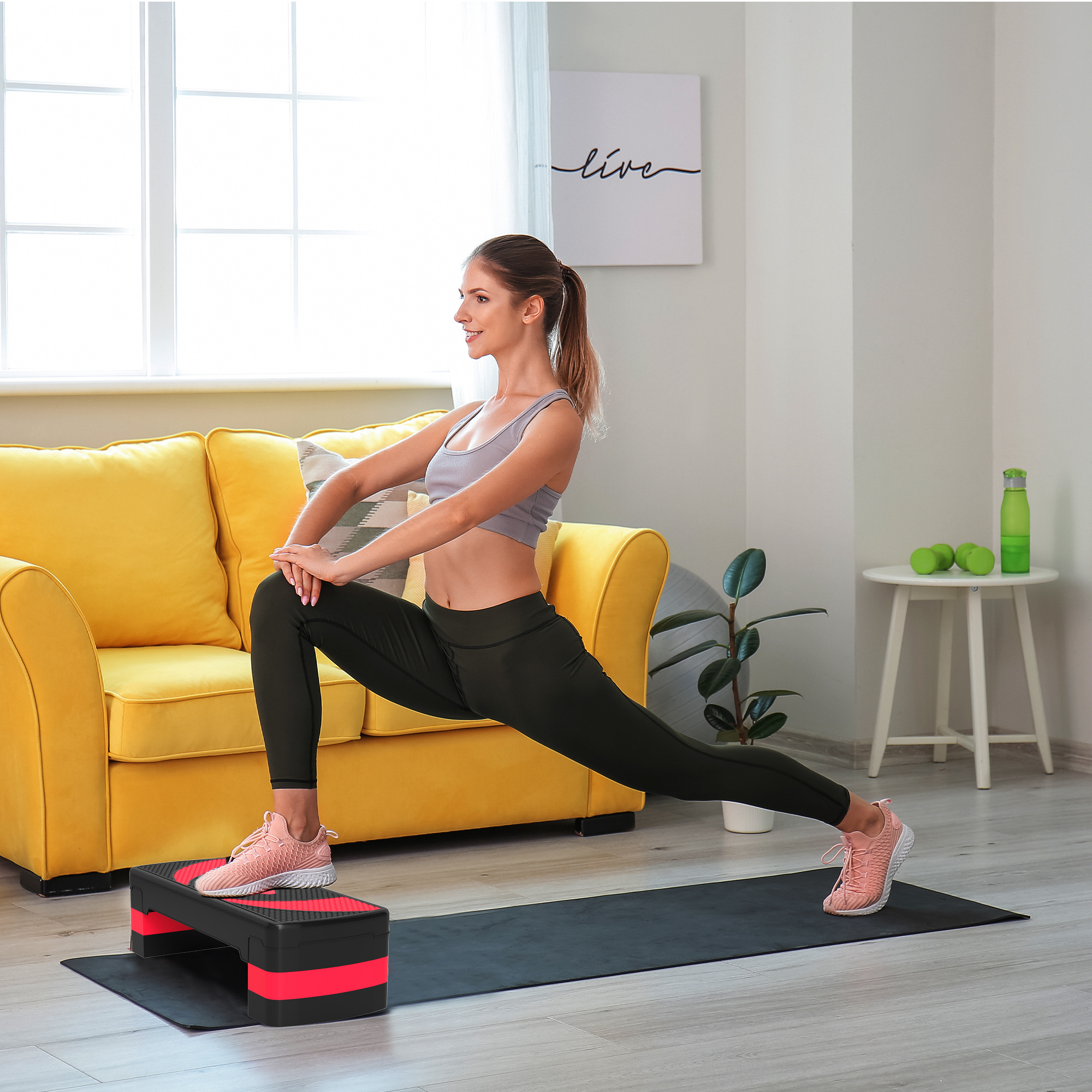 Una donna fa un affondo su una piattaforma fitness in un soggiorno.