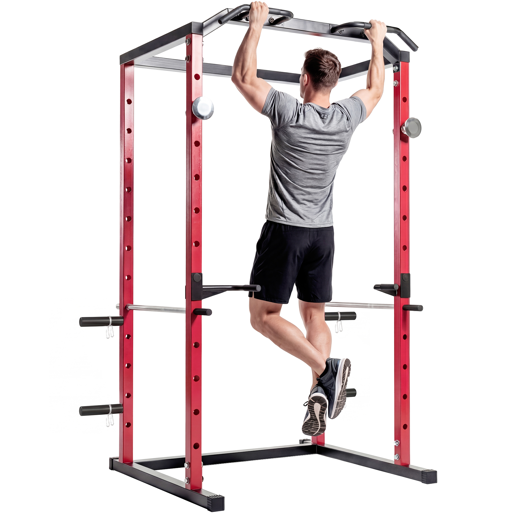 Uomo che fa trazioni su un power rack rosso con telaio nero.