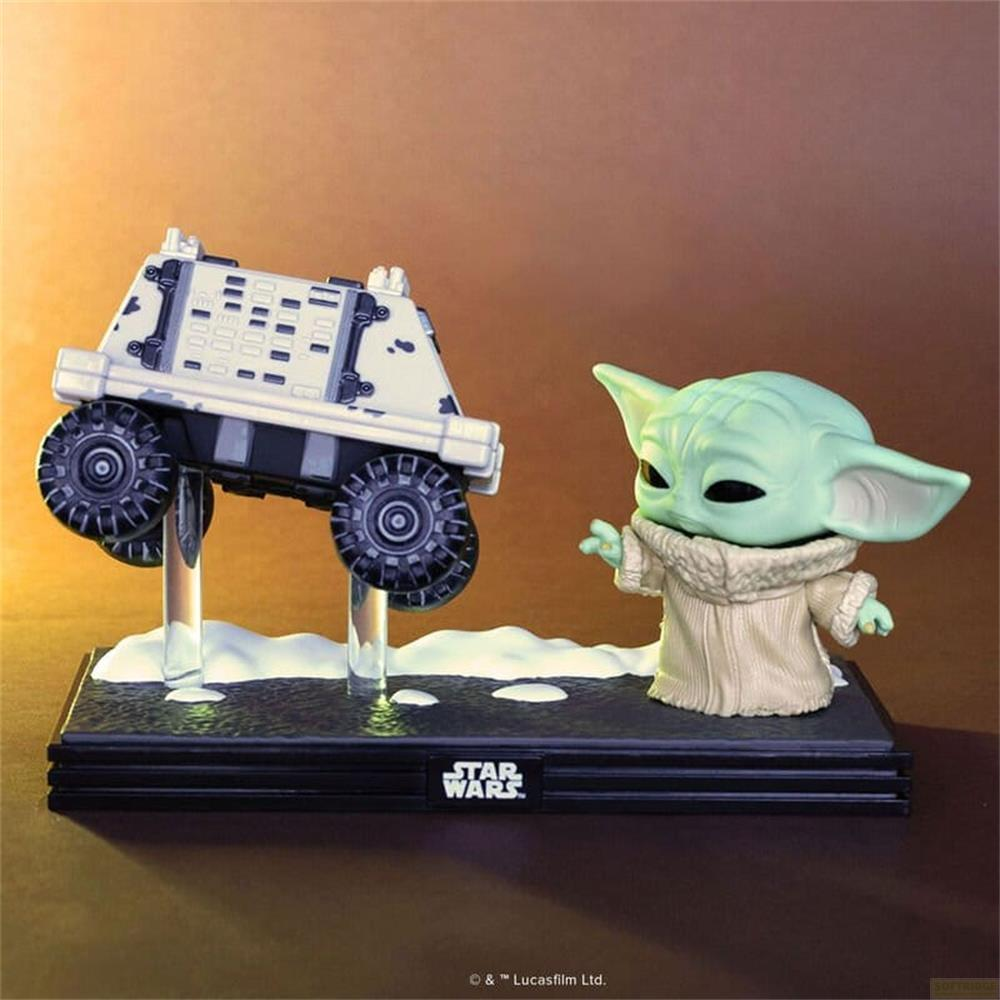 Baby Yoda Figur neben einem weißen Fahrzeug mit Rädern auf einer schwarzen Basis.