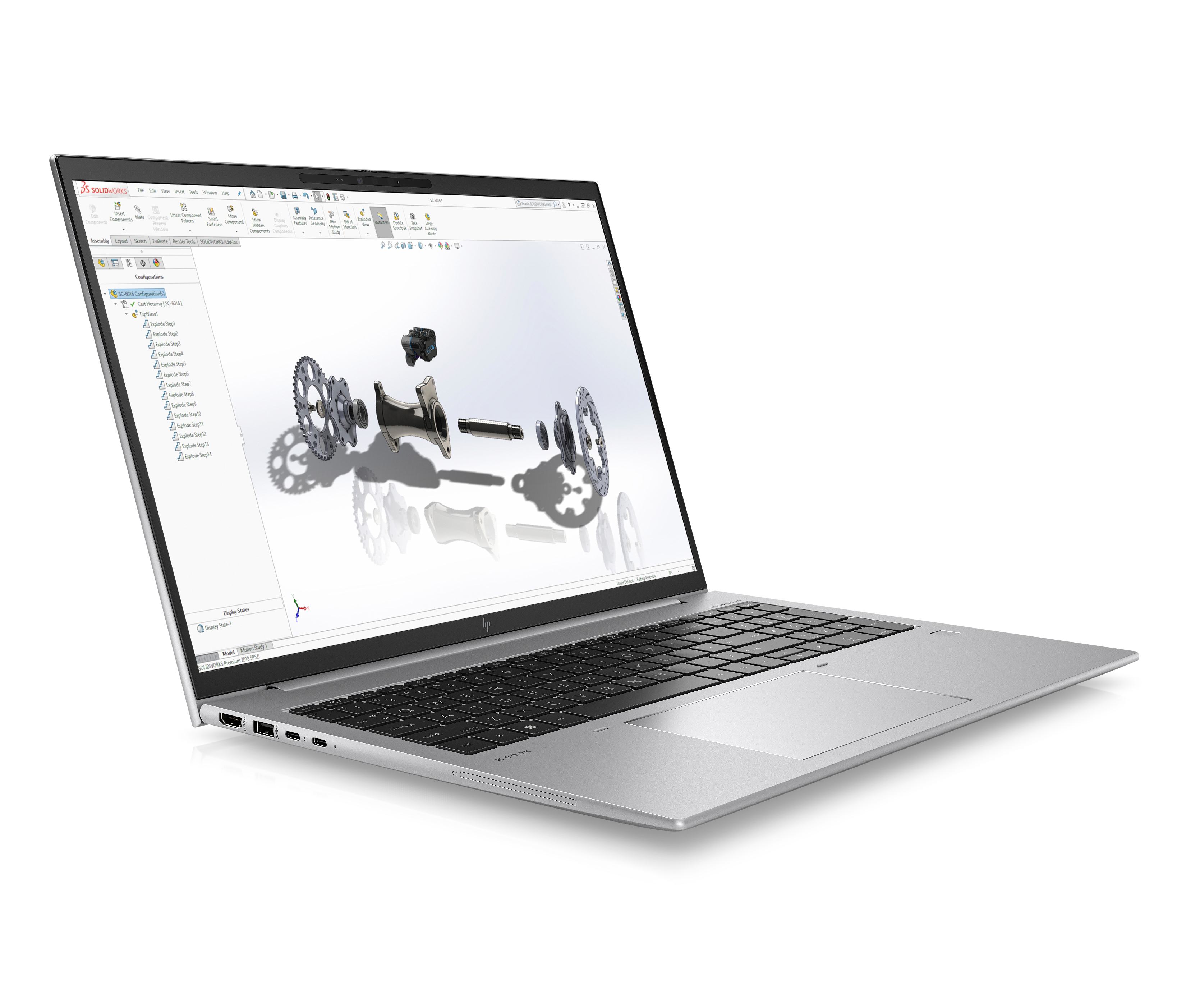 A silver laptop displays an exploded view of a mechanical component on its screen.