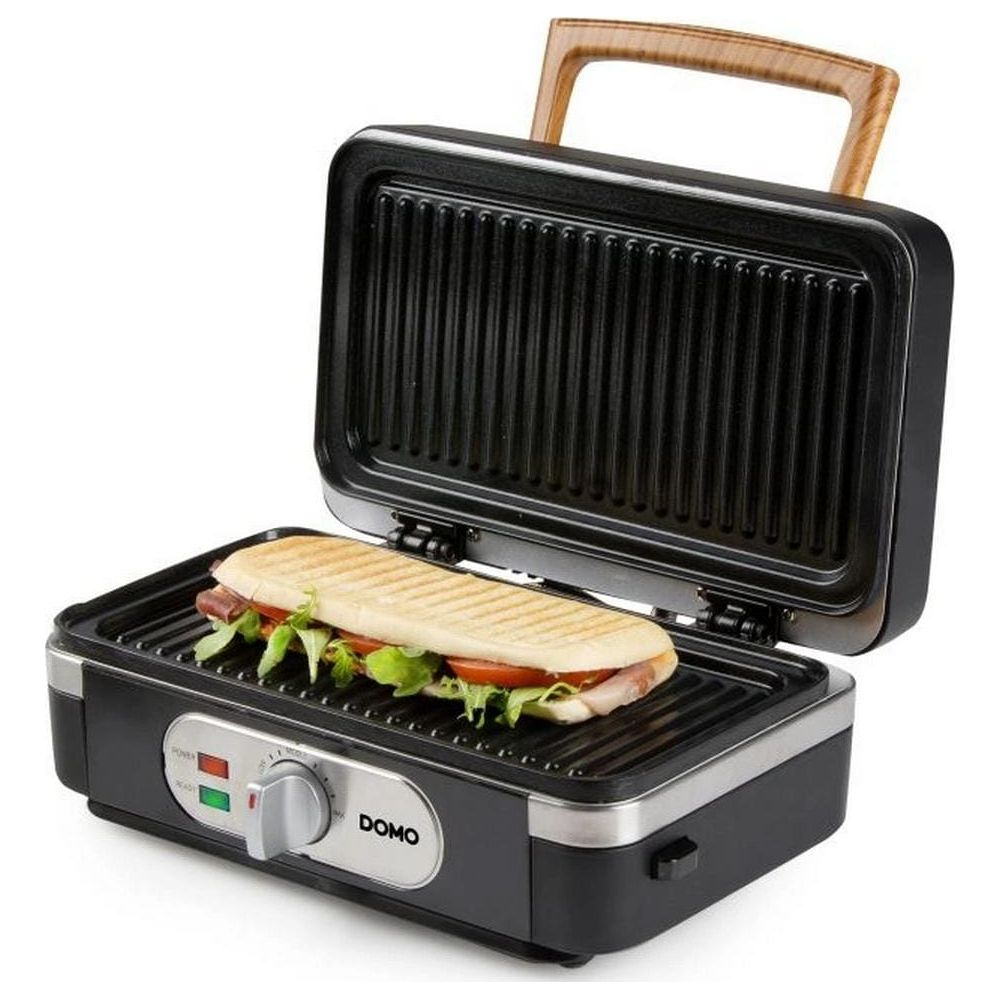 Una bistecchiera aperta con un panino sulla piastra inferiore.