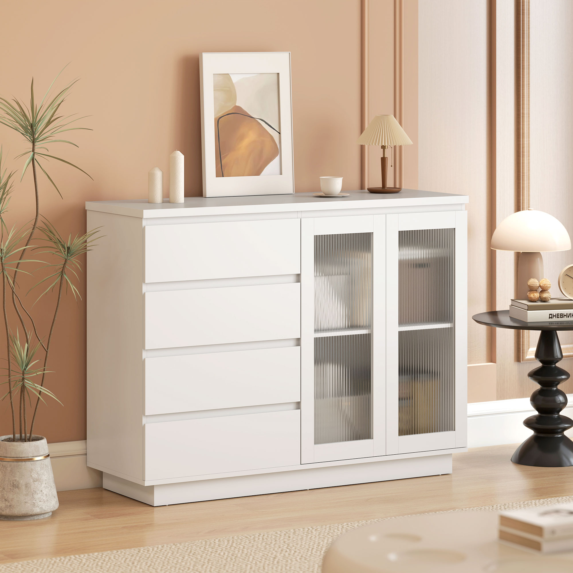 Un mobile bianco con cassetti e ante in vetro, decorato con pianta e arte.