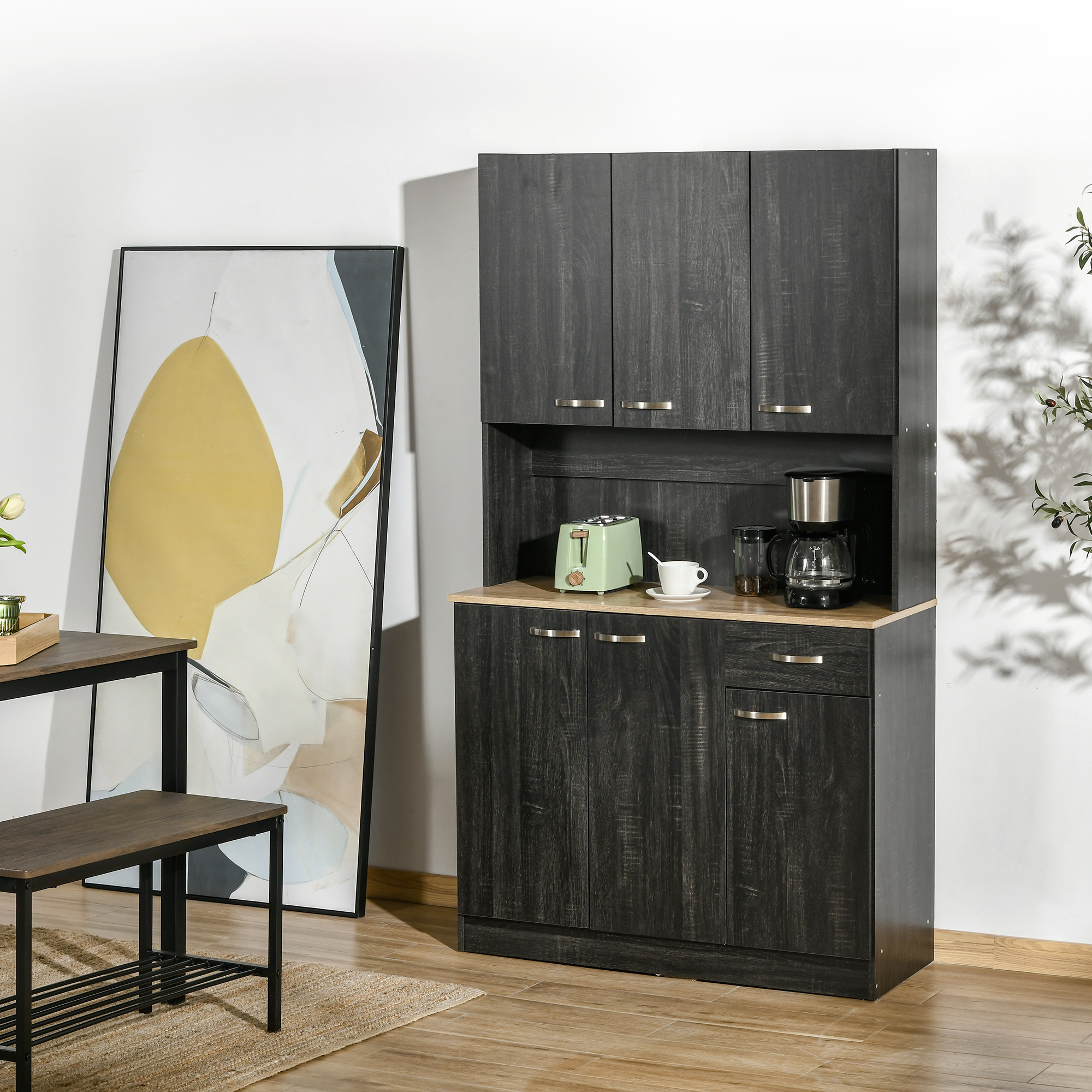 Mobile in legno scuro con macchina da caffè, tostapane e opera d'arte.