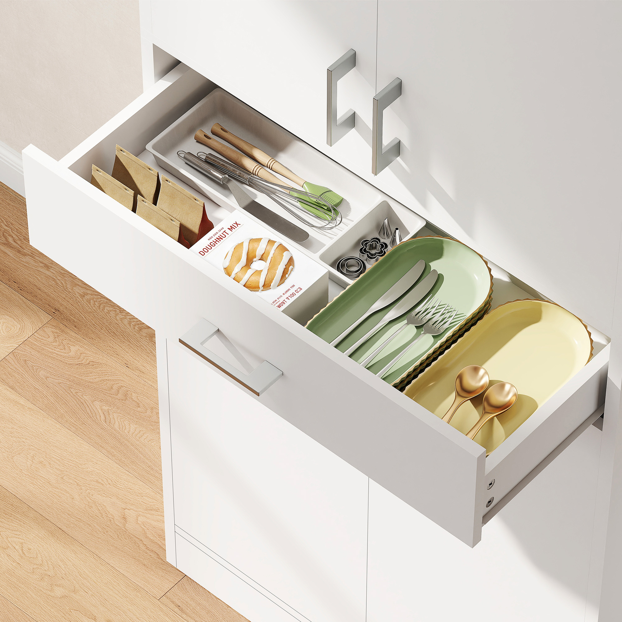 Cassetto da cucina aperto con utensili, scatola per preparato per ciambelle e piatti.