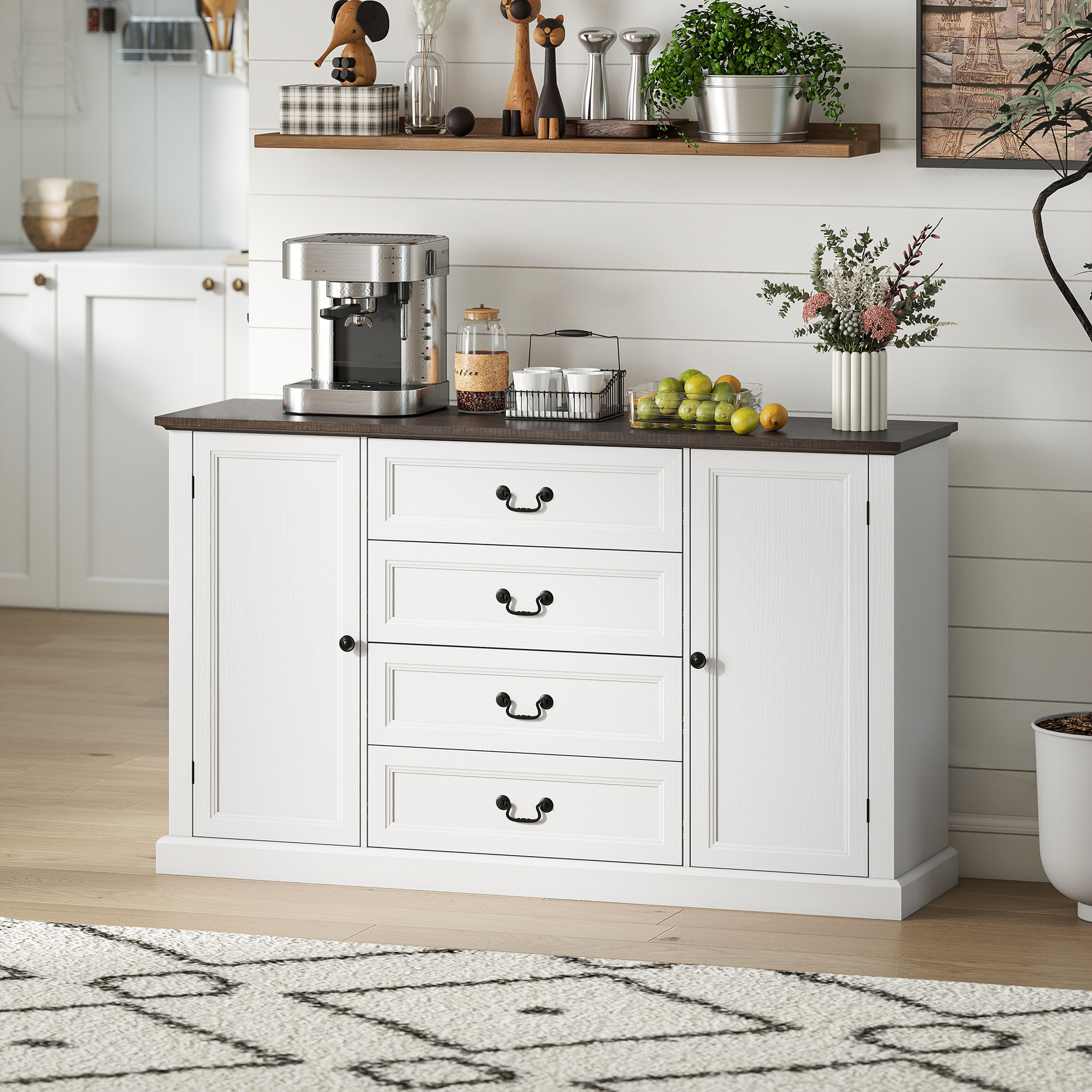 Una credenza bianca con piano scuro, con macchina da caffè, frutta e decorazioni.